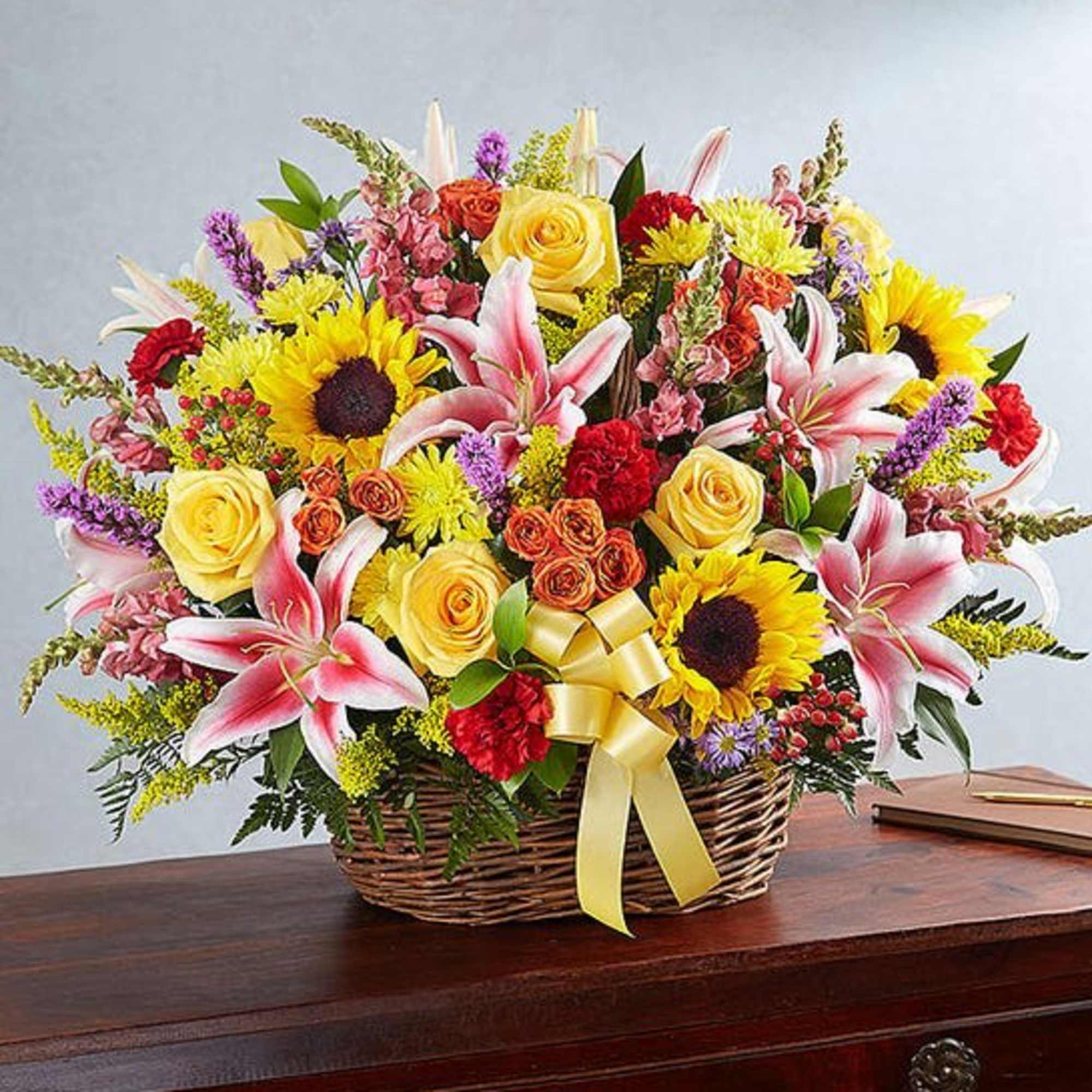 There&rsquo;s a warmth and radiance to our bright basket arrangement, which beautifully