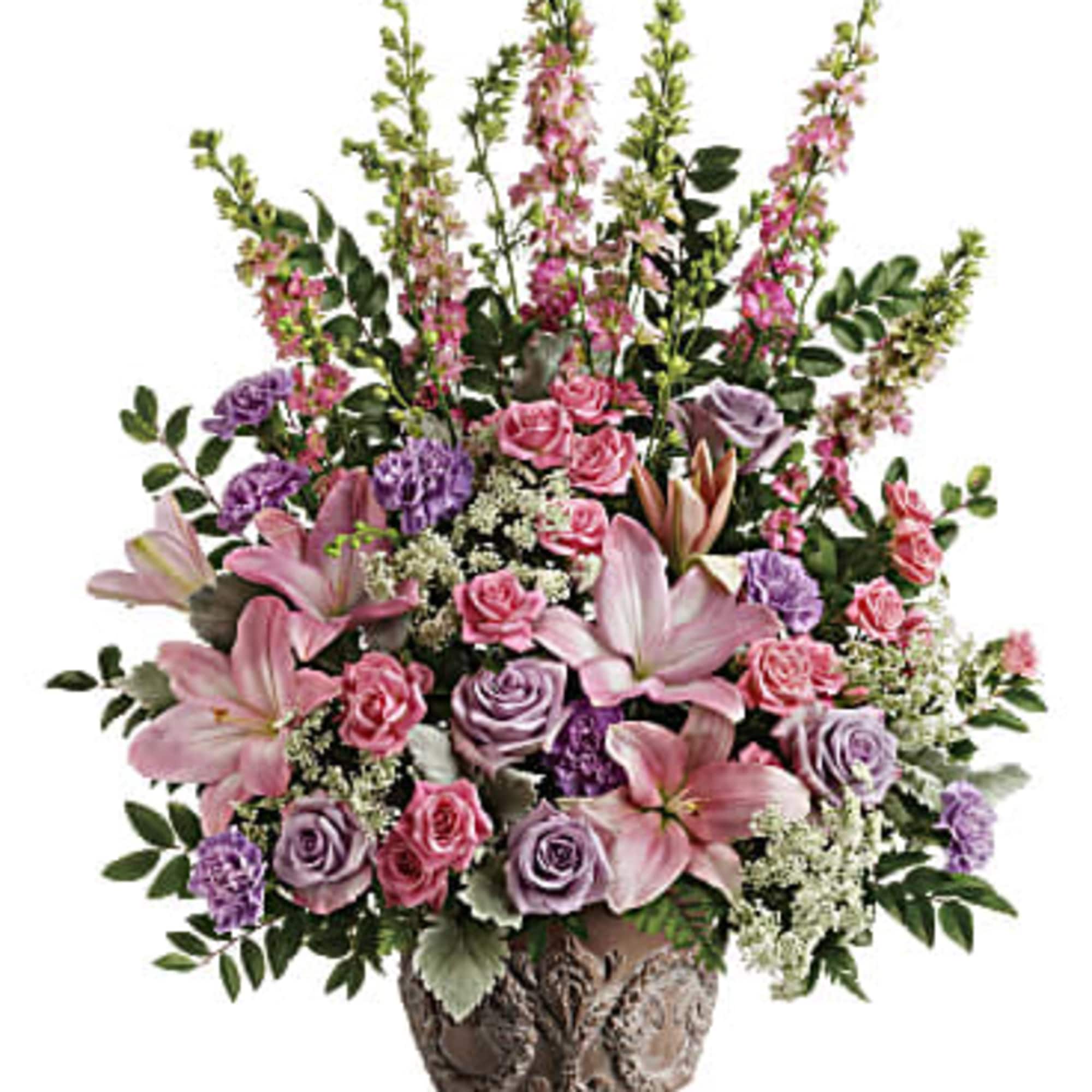 This soft pink arrangement features lavender roses, pink spray roses, pink asiatic