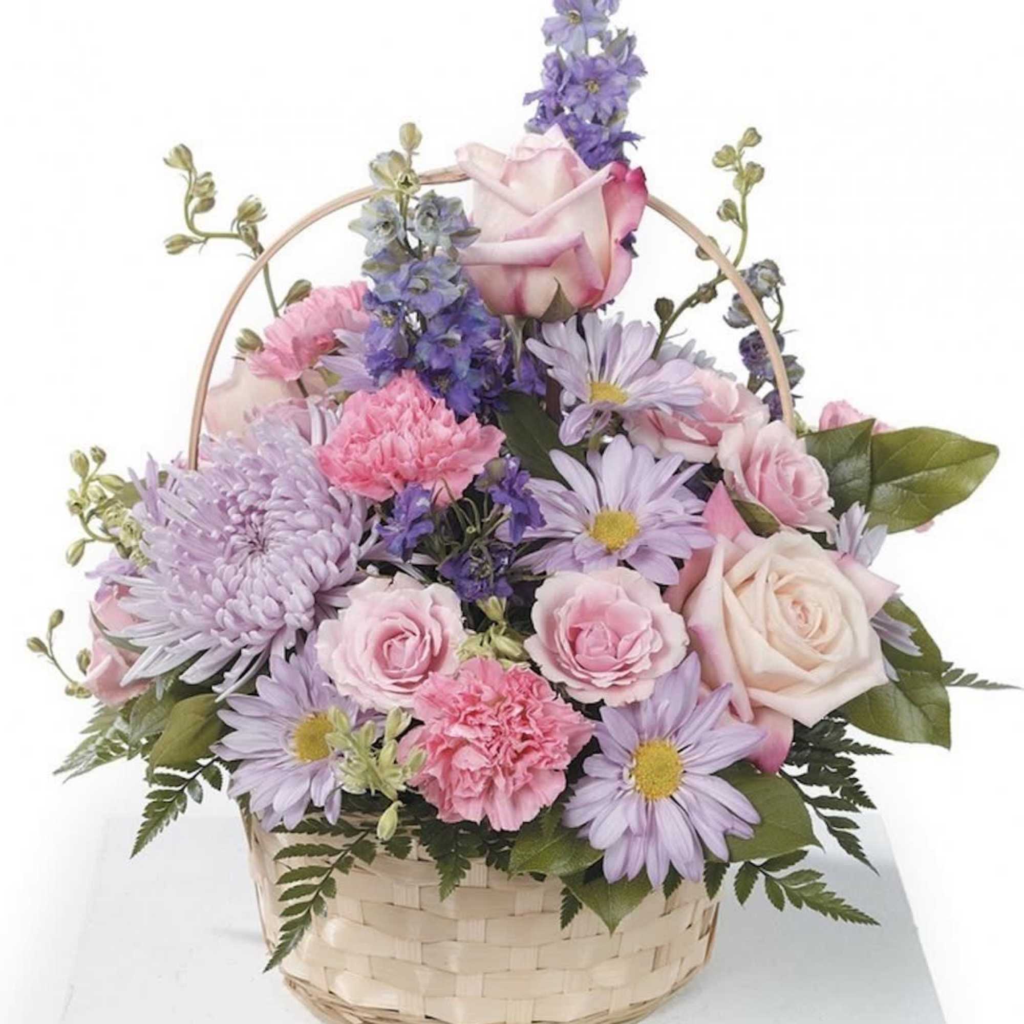 White wicker basket with pinks, lavenders and creams to show a soft