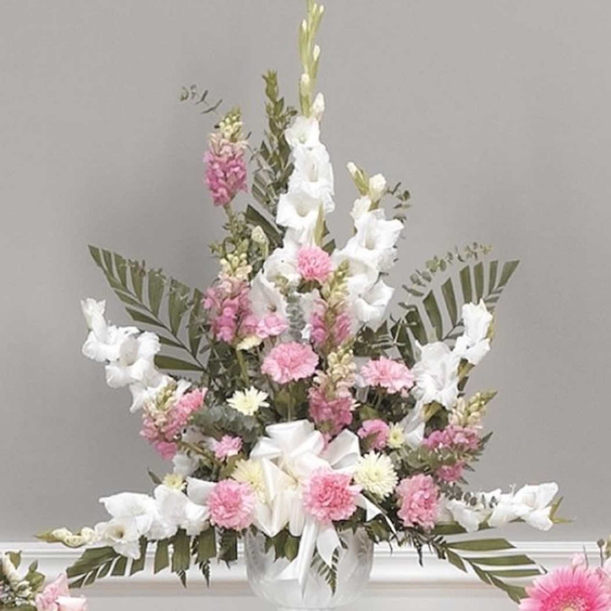 White Gladiolus cascade from a bouquet of Pink Snapdragons, Carnations and designer White Gladiolus cascade from a bouquet of Pink Snapdragons, Carnations and designer