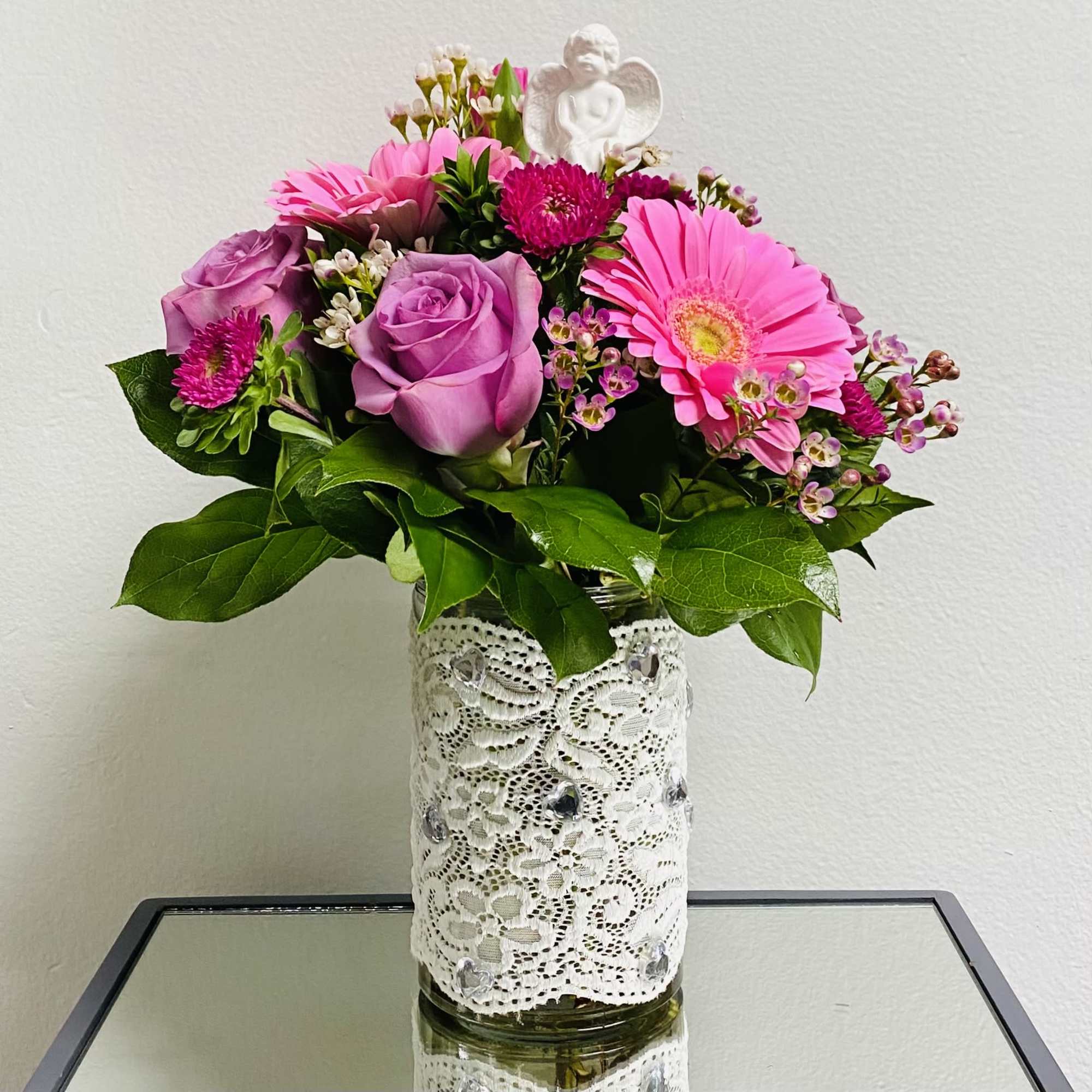 A mixture of seasonal pink flowers such as gerber, roses, asters with