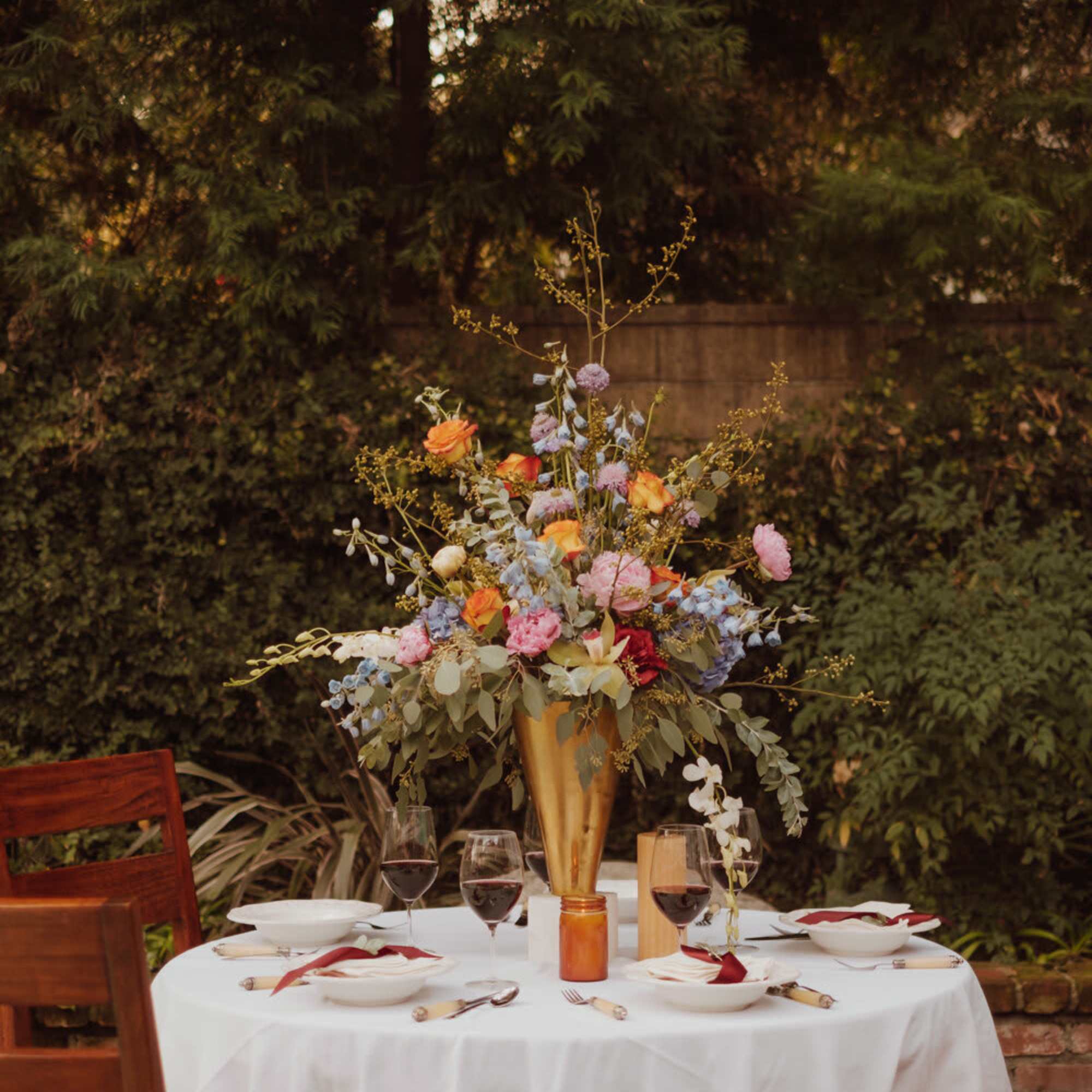 A classic draping floral centerpiece brings the whole table together, exuding timeless