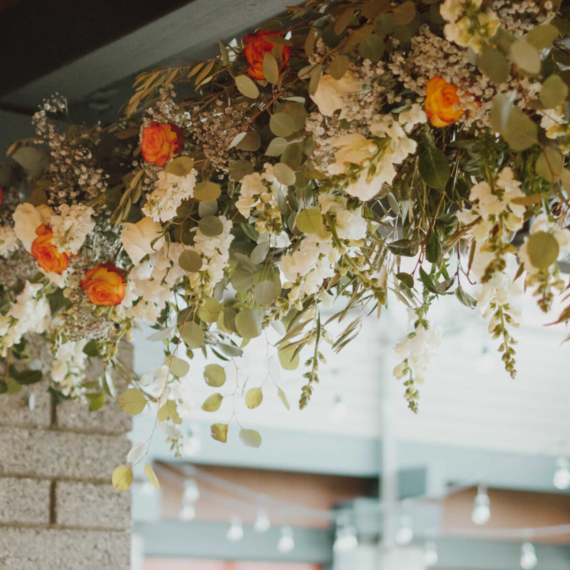 This hanging floral arrangement brings atmospheric beauty from overhead. The backdrop can