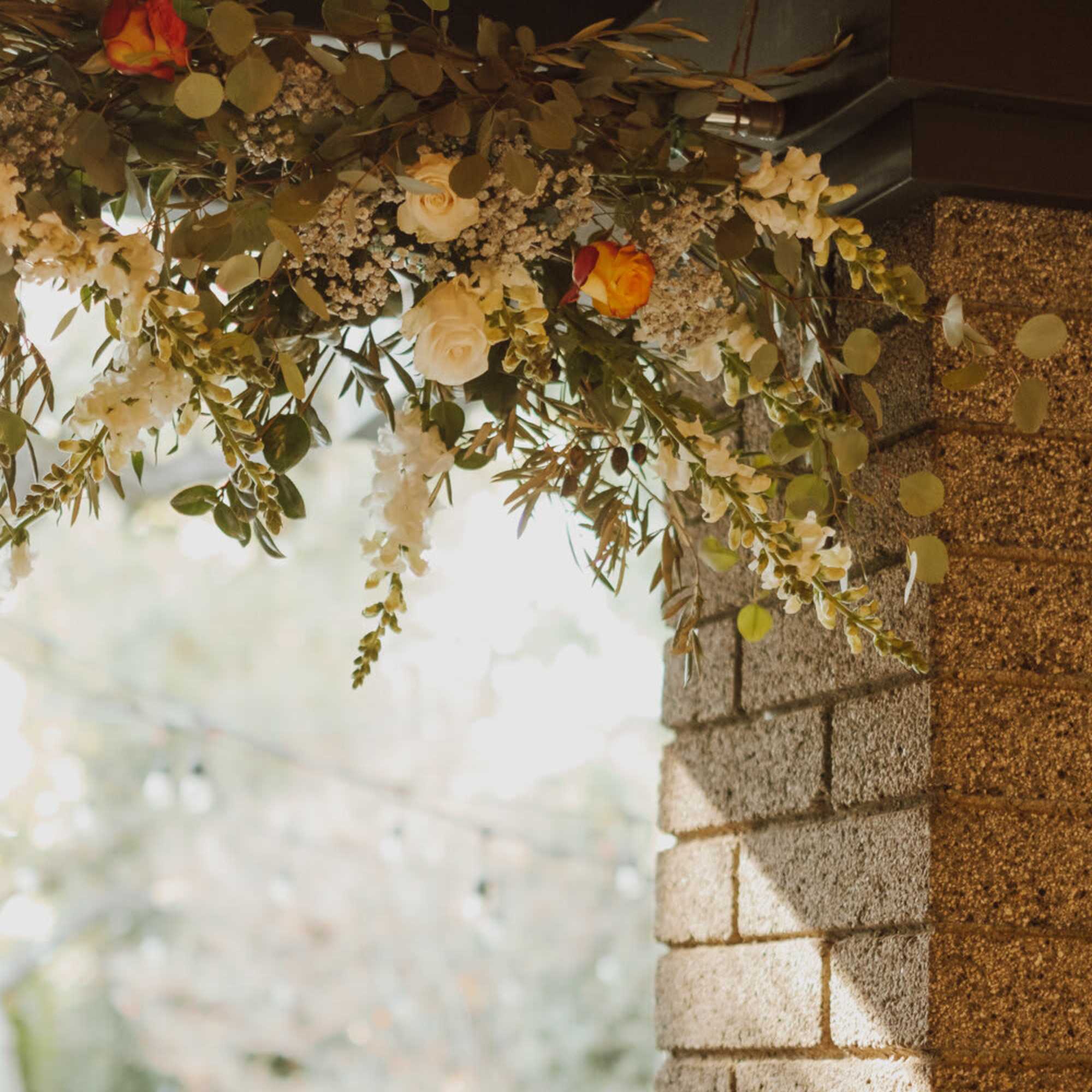 This hanging floral arrangement brings atmospheric beauty from overhead. The backdrop can