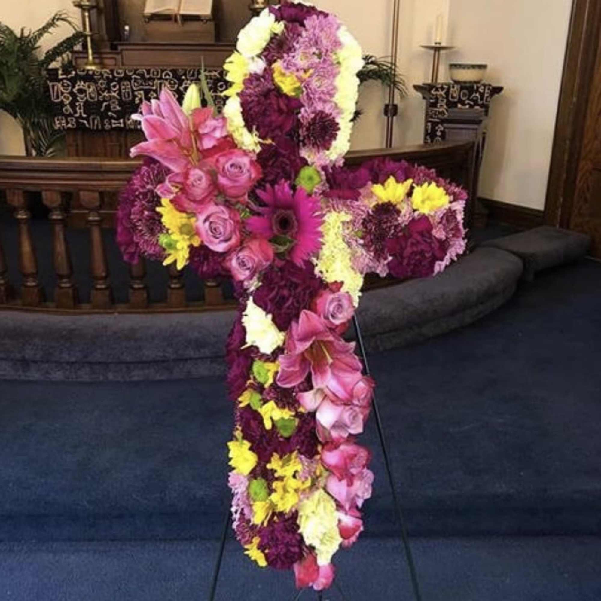 Twenty inch cross filled with seasonal flowers 