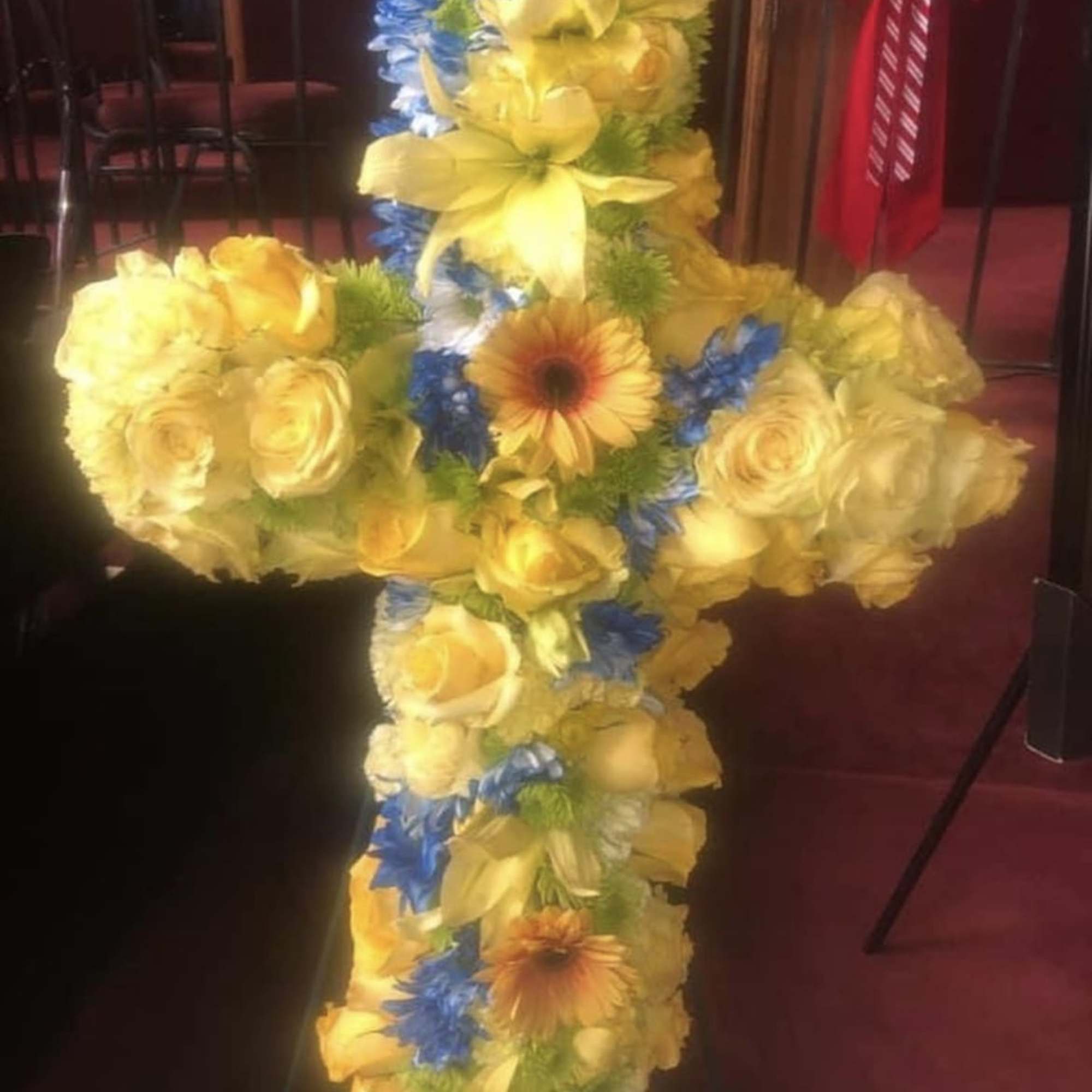 Twenty inch cross filled with seasonal flowers 