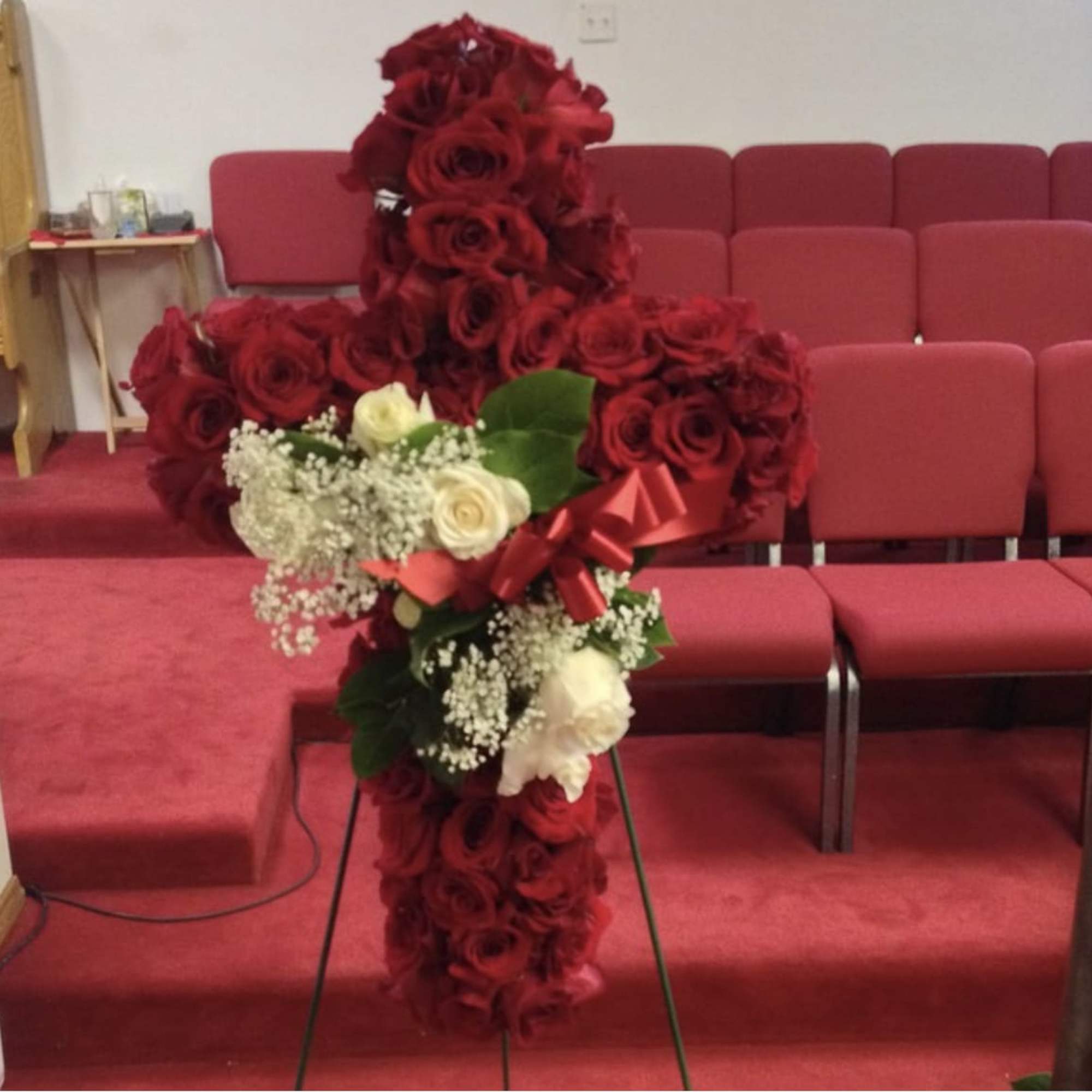 Twenty inch cross filled with roses