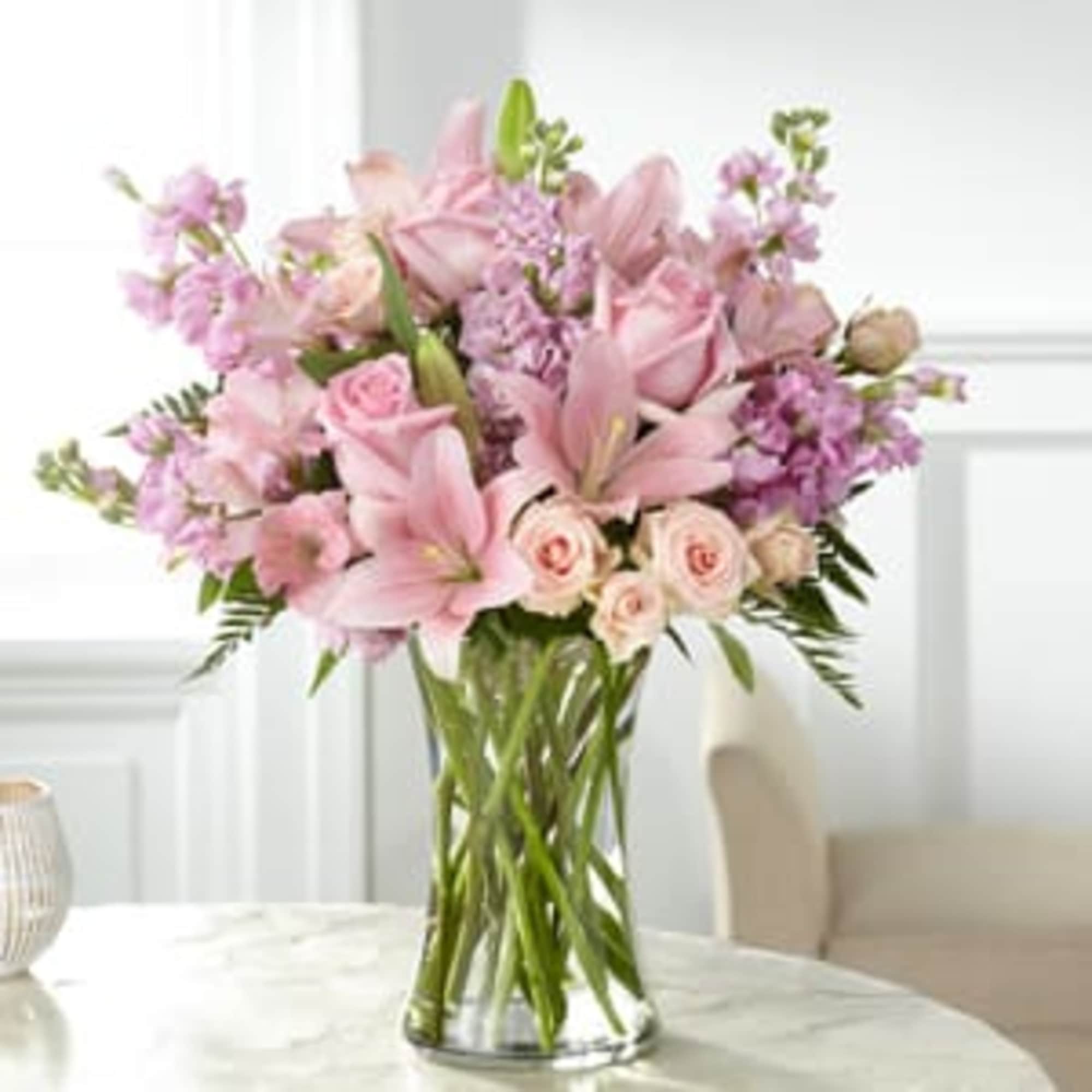 An array of blushing pink blooms come together beautifully to express your