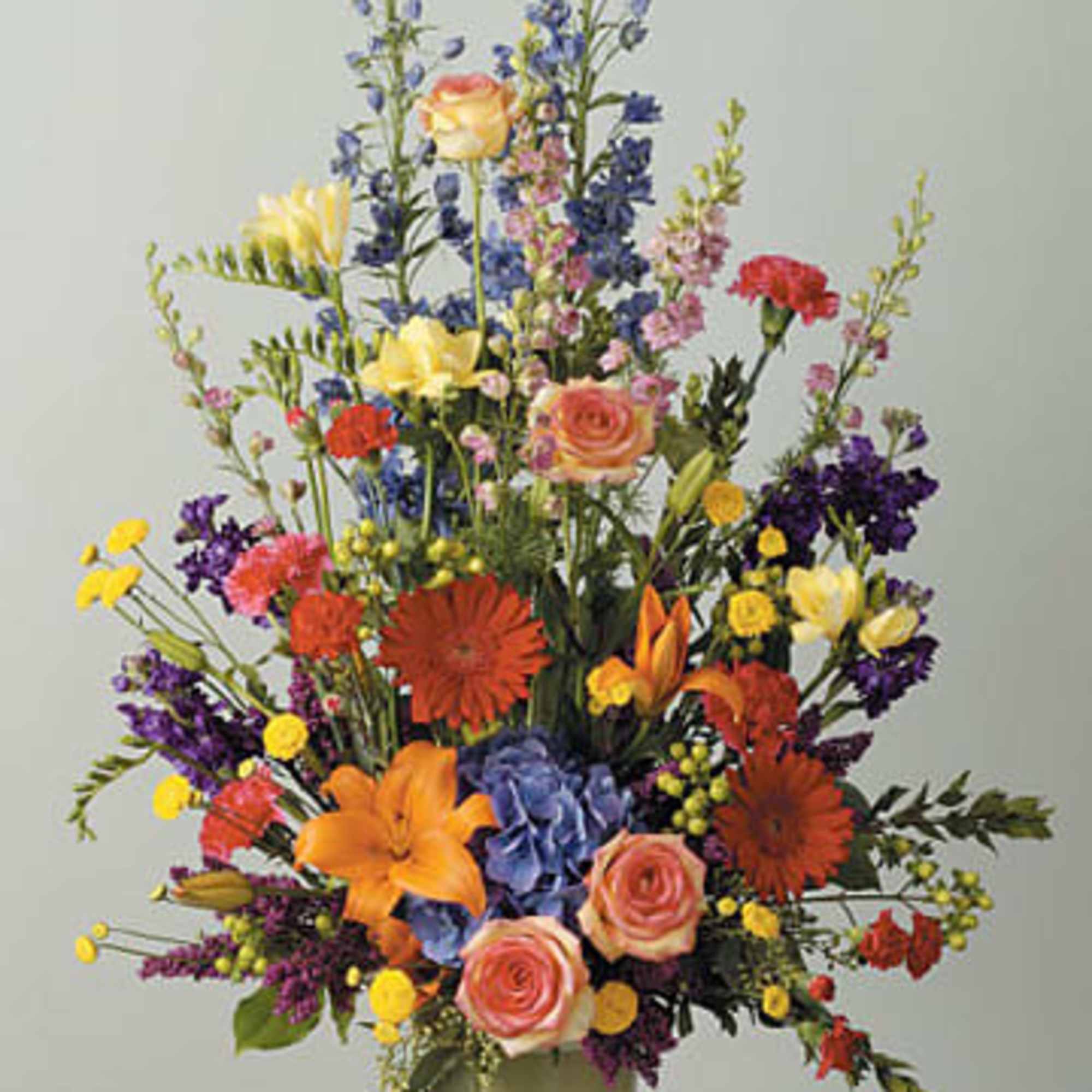 Lilies, mini Carnations, gerber daisies, hydrangea freesia carnations, stock, heather, larkspur, hypericum