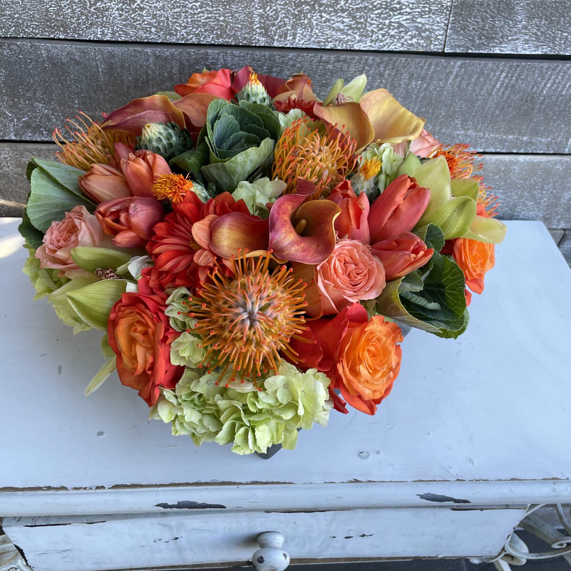 Low and lush gorgeously full arrangement in a low square vase. Filled Low and lush gorgeously full arrangement in a low square vase. Filled