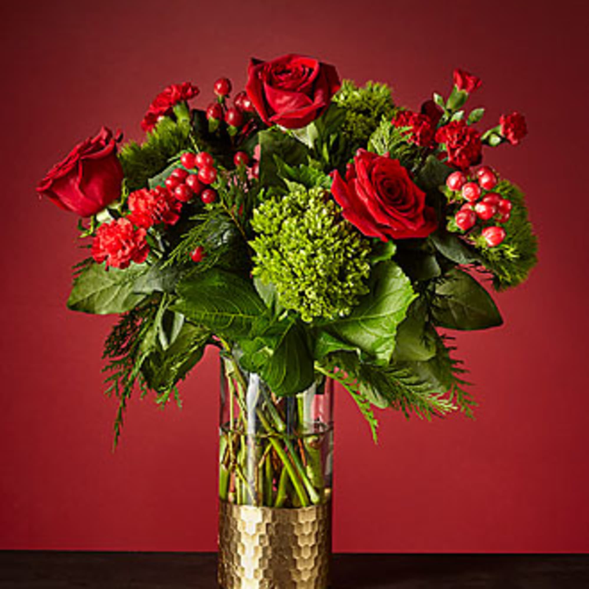 GOLD DIPPED VASE WITH EVERGREENS, RED ROSES, RED MINI CARNATIONS, RED BERRIES GOLD DIPPED VASE WITH EVERGREENS, RED ROSES, RED MINI CARNATIONS, RED BERRIES