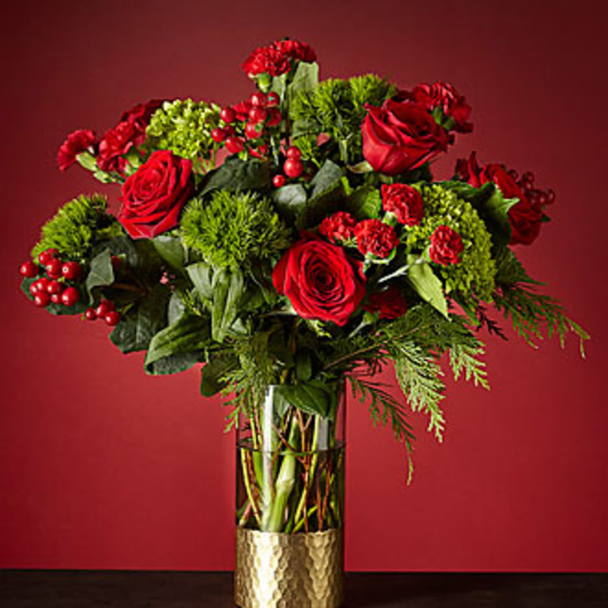 GOLD DIPPED VASE WITH EVERGREENS, RED ROSES, RED MINI CARNATIONS, RED BERRIES GOLD DIPPED VASE WITH EVERGREENS, RED ROSES, RED MINI CARNATIONS, RED BERRIES