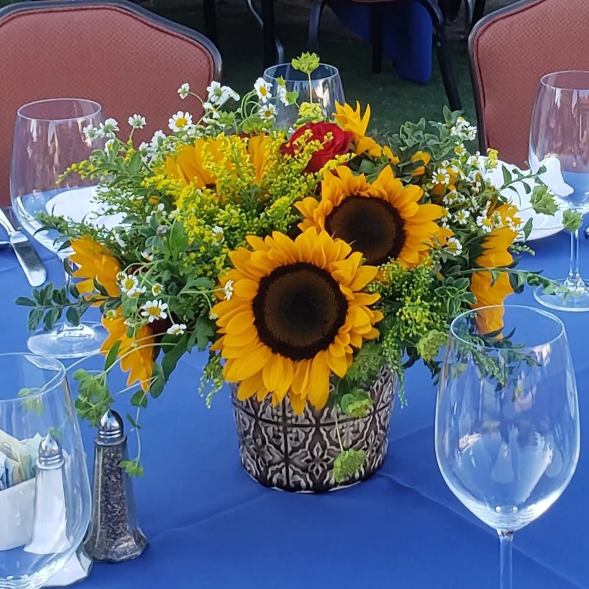 Large Sunflowers tuck in a garden vibe with pops of red  Large Sunflowers tuck in a garden vibe with pops of red