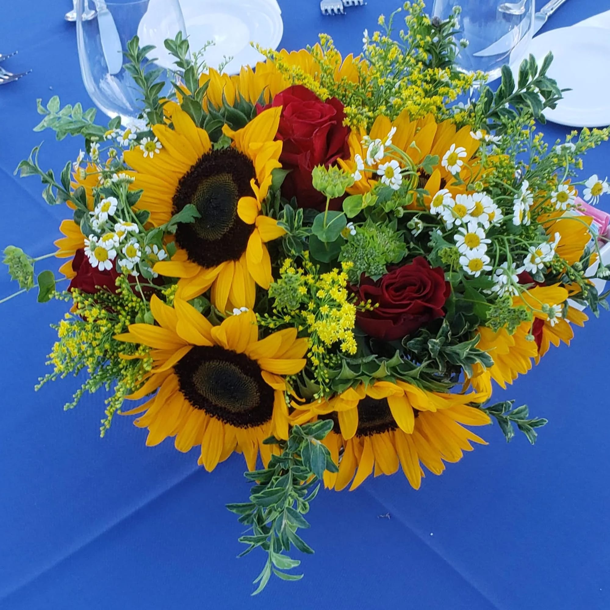 Large Sunflowers tuck in a garden vibe with pops of red  Large Sunflowers tuck in a garden vibe with pops of red