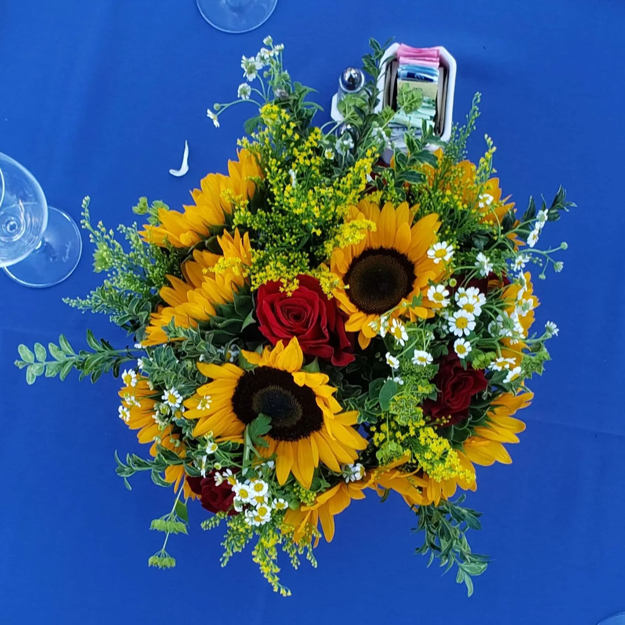 Large Sunflowers tuck in a garden vibe with pops of red  Large Sunflowers tuck in a garden vibe with pops of red