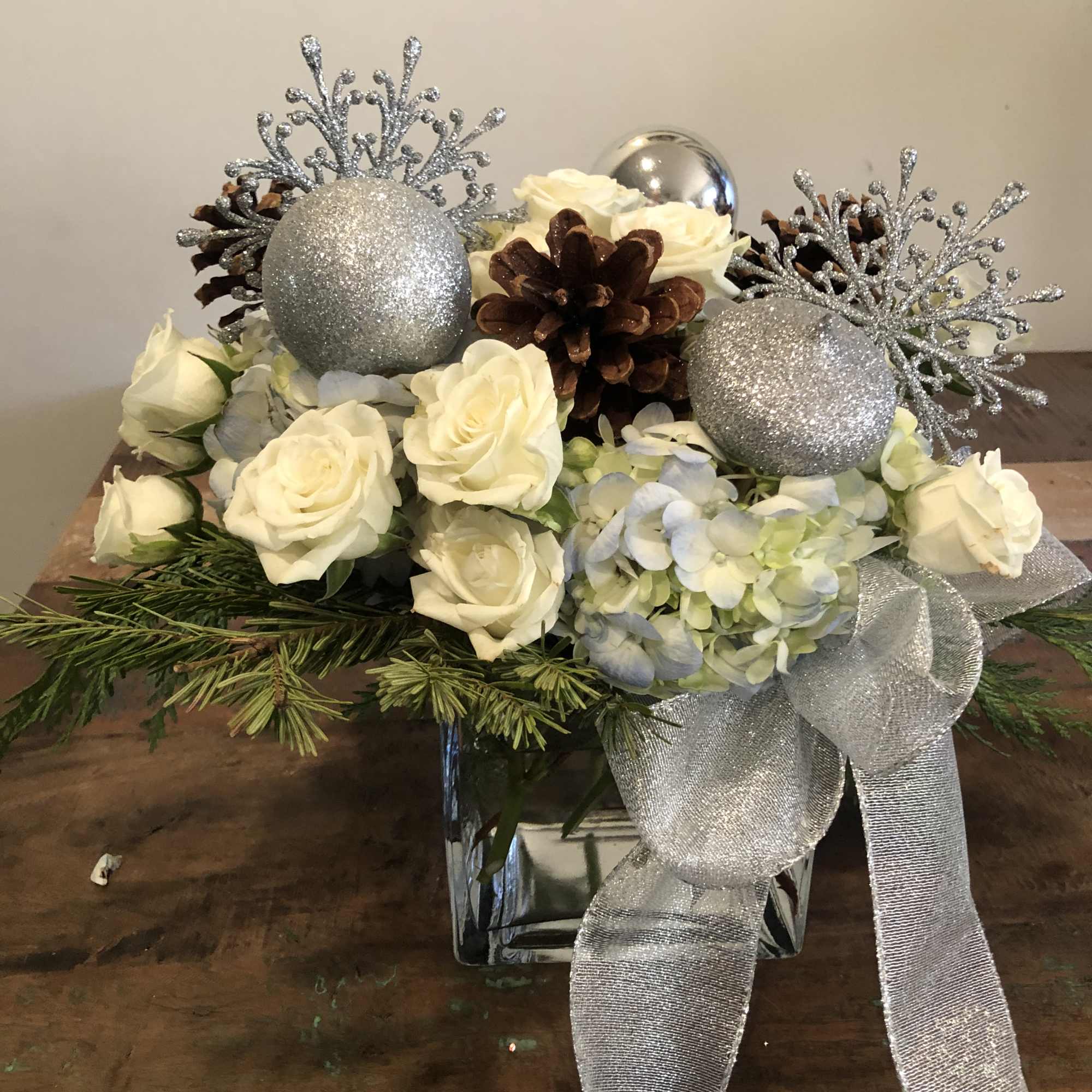Blue hydrangea, white roses, ornaments. Pine cones and ribbon  Blue hydrangea, white roses, ornaments. Pine cones and ribbon