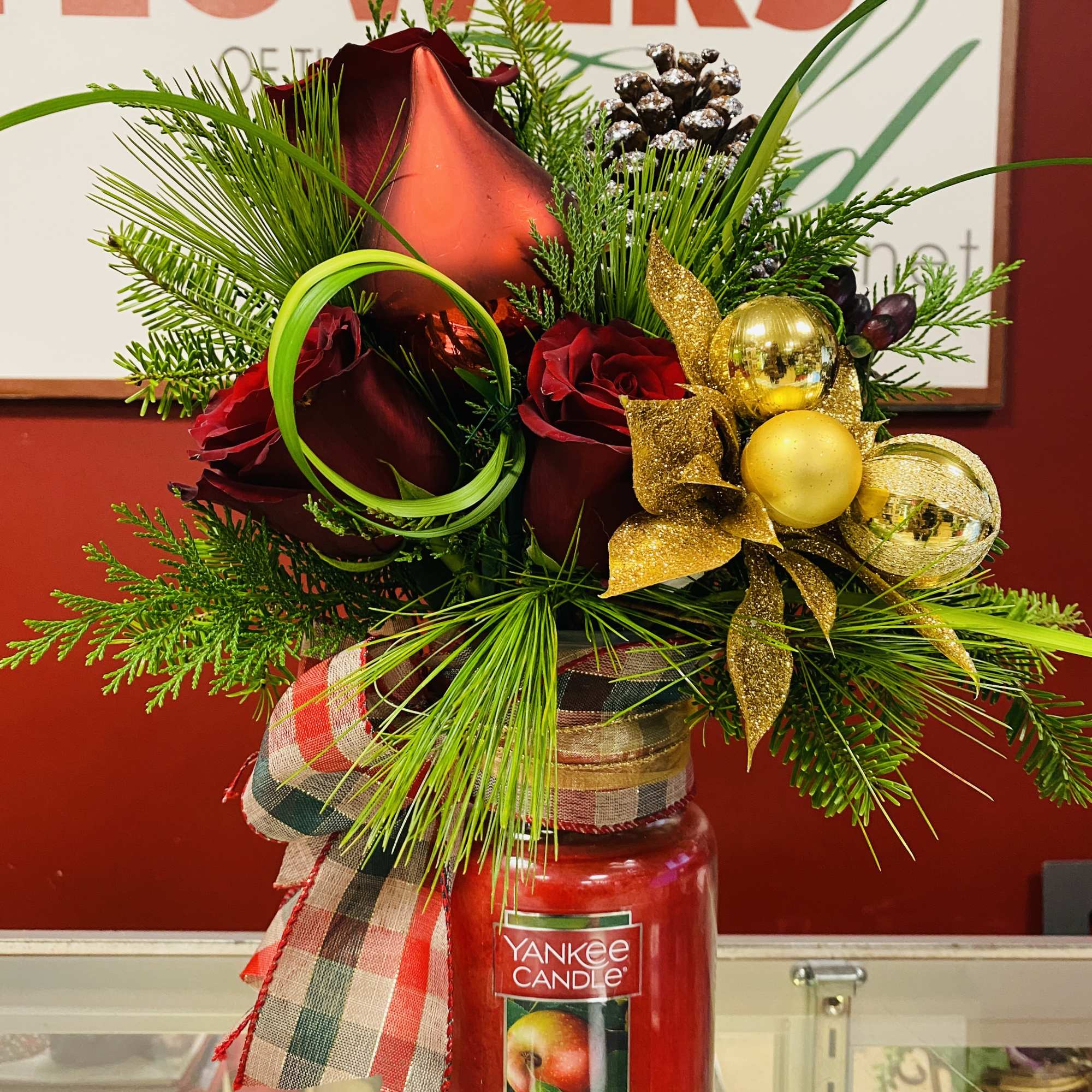 Beautiful arrangement on top of a Yankee Candle.