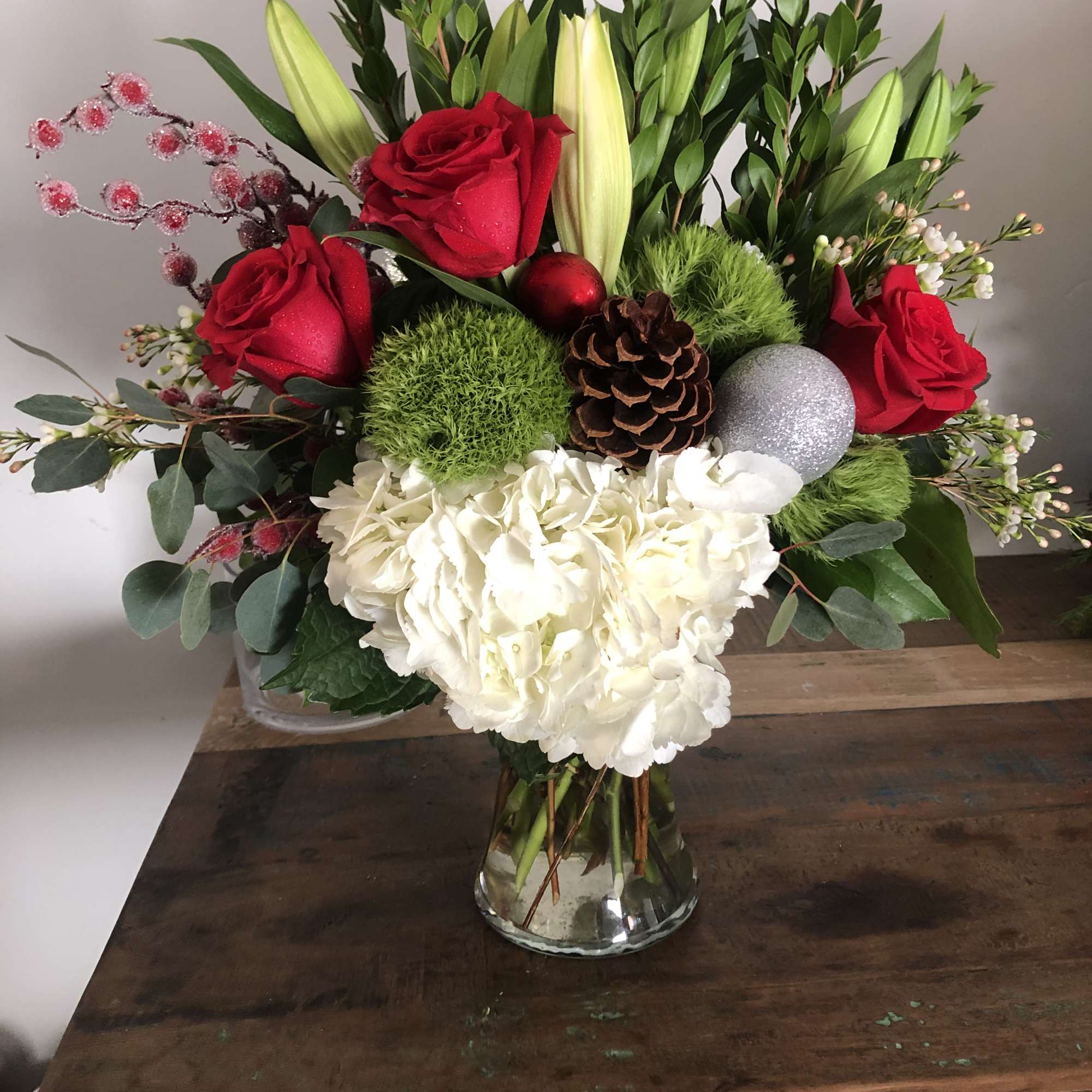 Hydrangea, red roses, evergreen and green ball dianthus and lilies  Hydrangea, red roses, evergreen and green ball dianthus and lilies