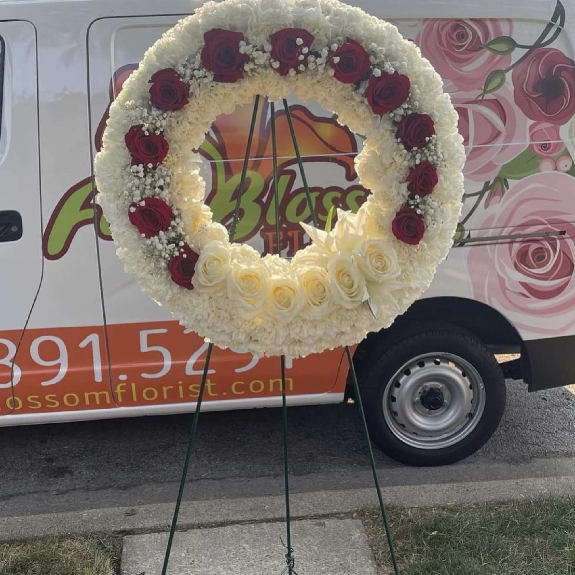 Twenty inch wreath filled with roses and carnations