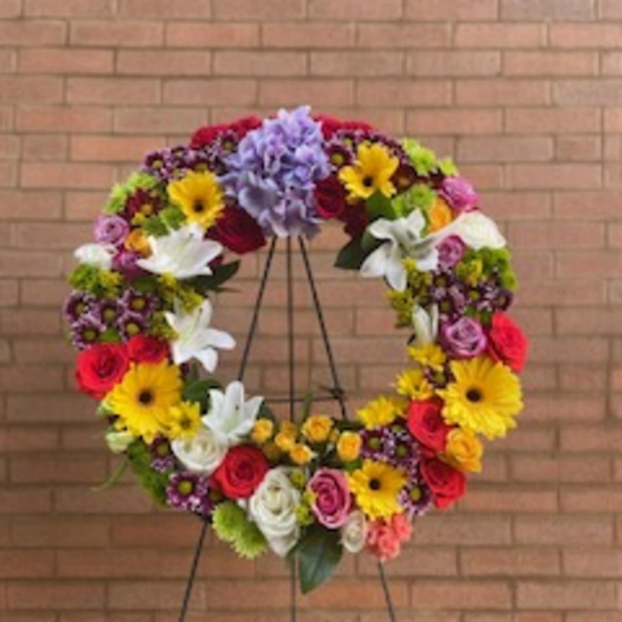 A 21inch round wreath with mixed flowers (color of choice)