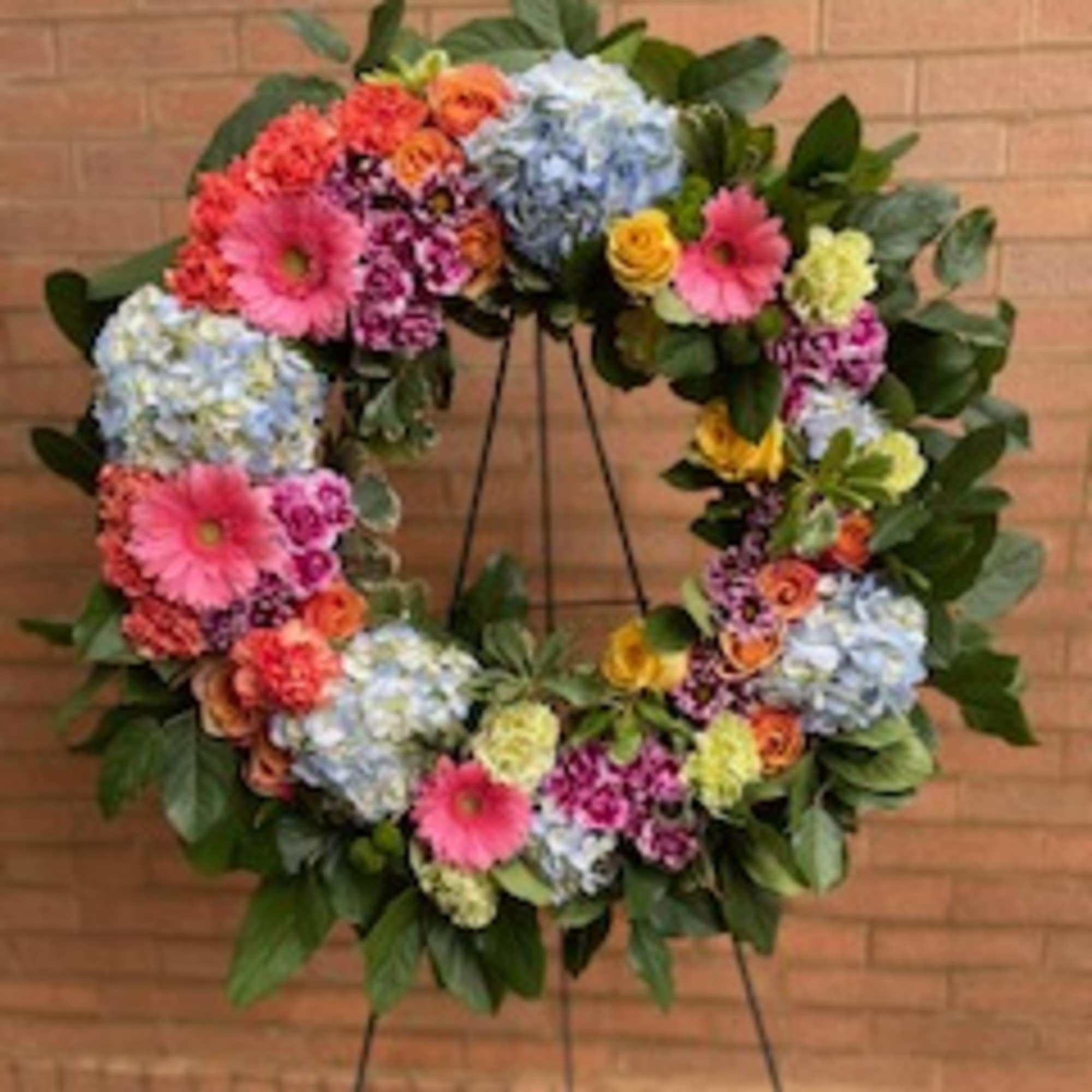 A 21inch round wreath with mixed flowers (color of choice)