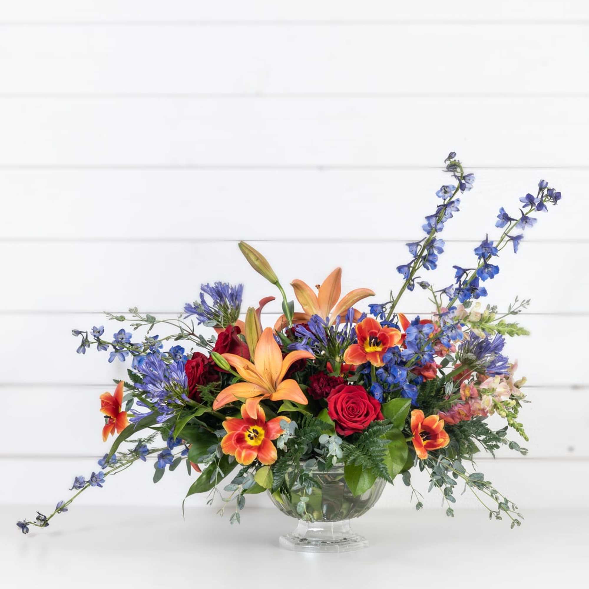 Bright palette of florals in a lush compote arrangement