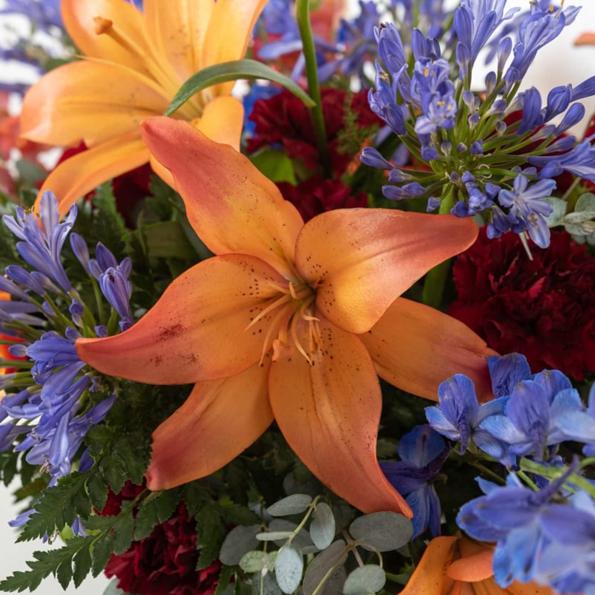 Bright palette of florals in a lush compote arrangement