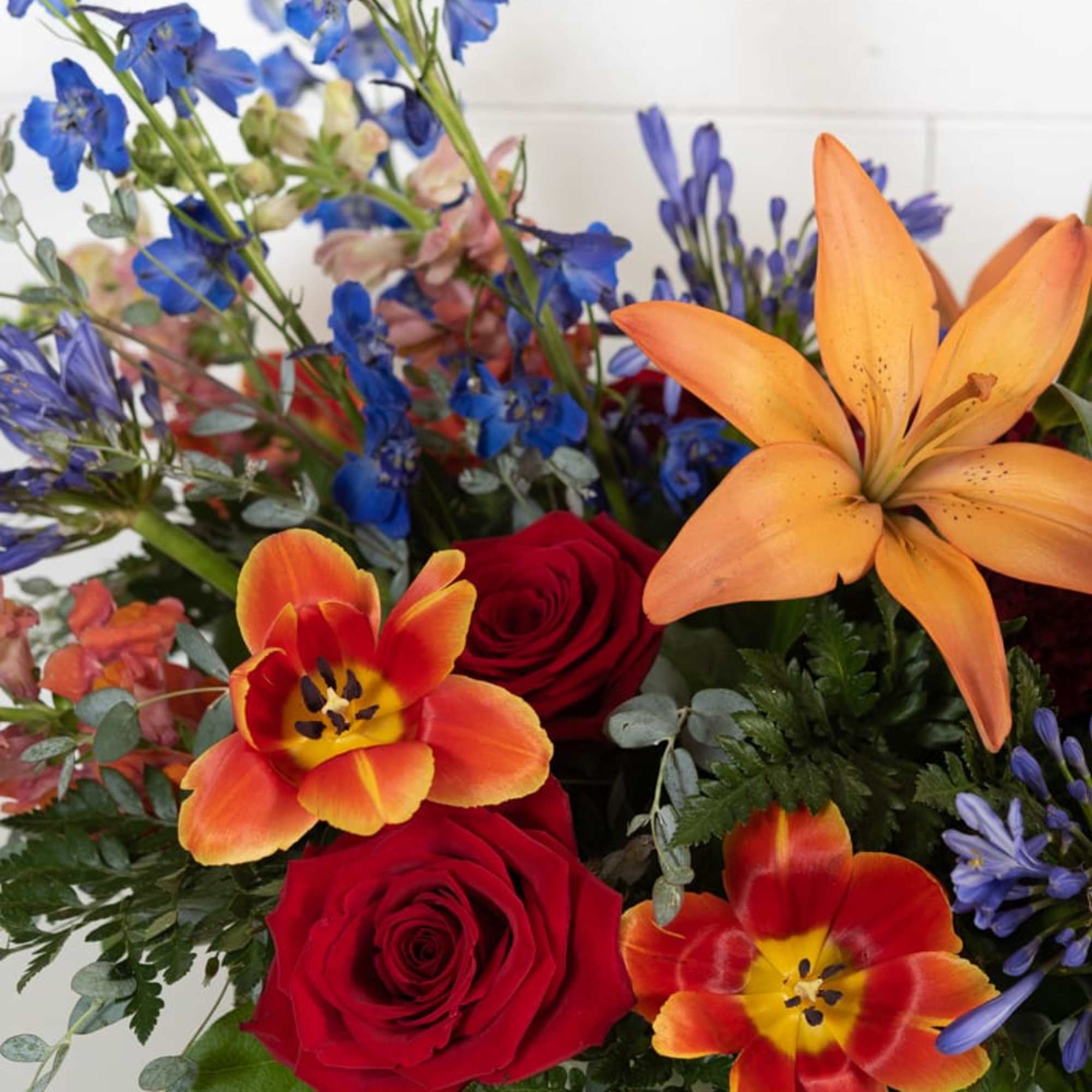Bright palette of florals in a lush compote arrangement