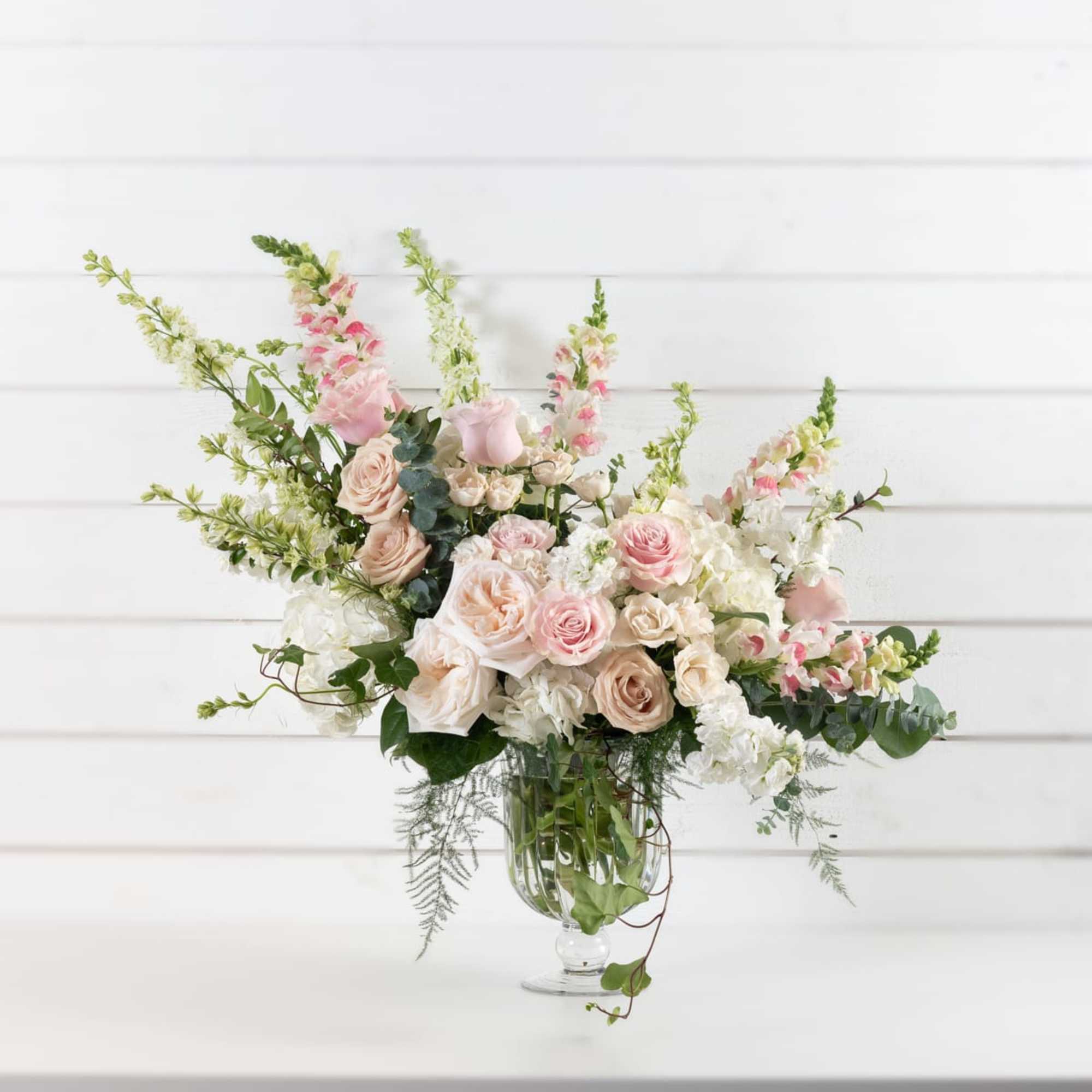 Just say Romance, romance, romance with this lush assortment of roses, hydrangea