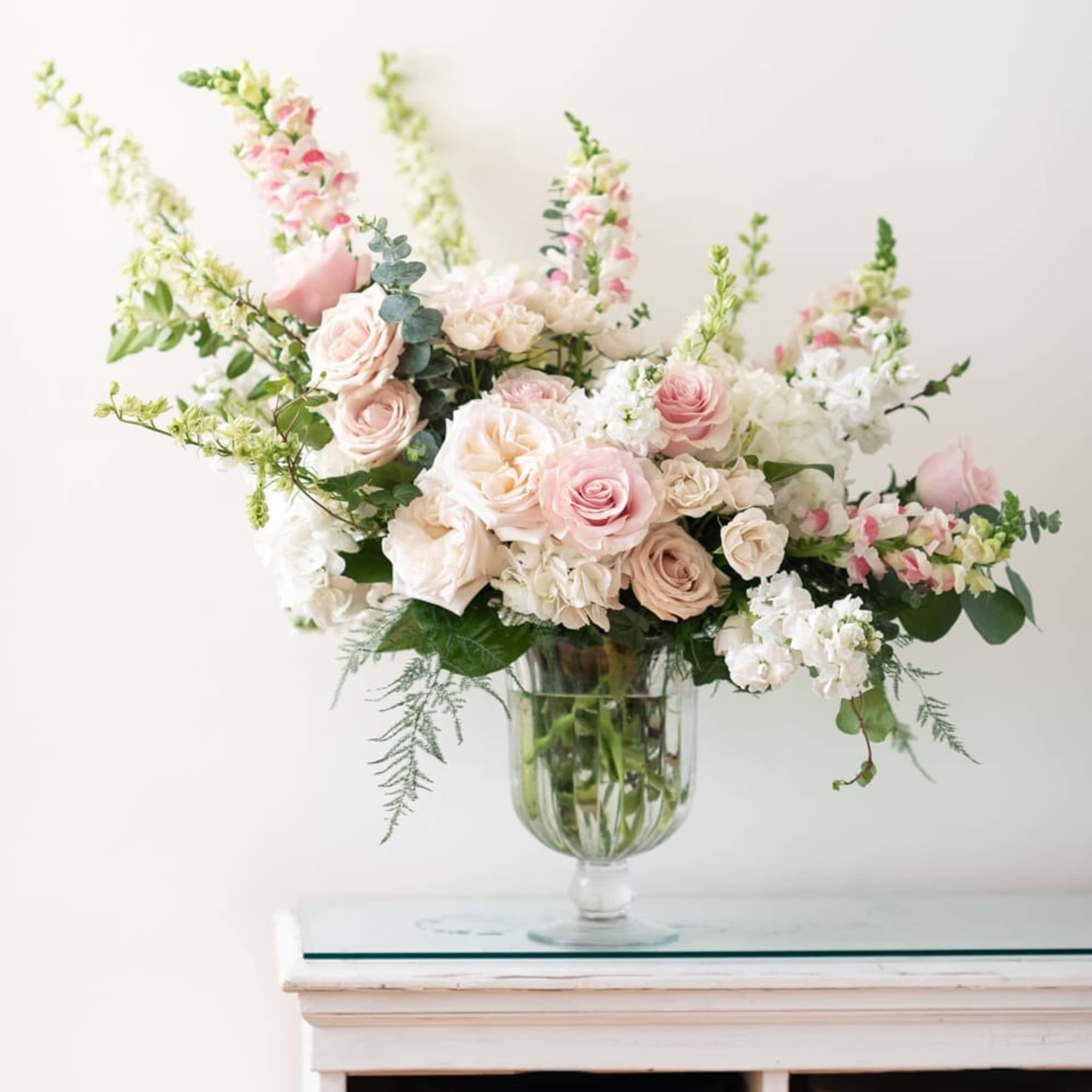 Just say Romance, romance, romance with this lush assortment of roses, hydrangea