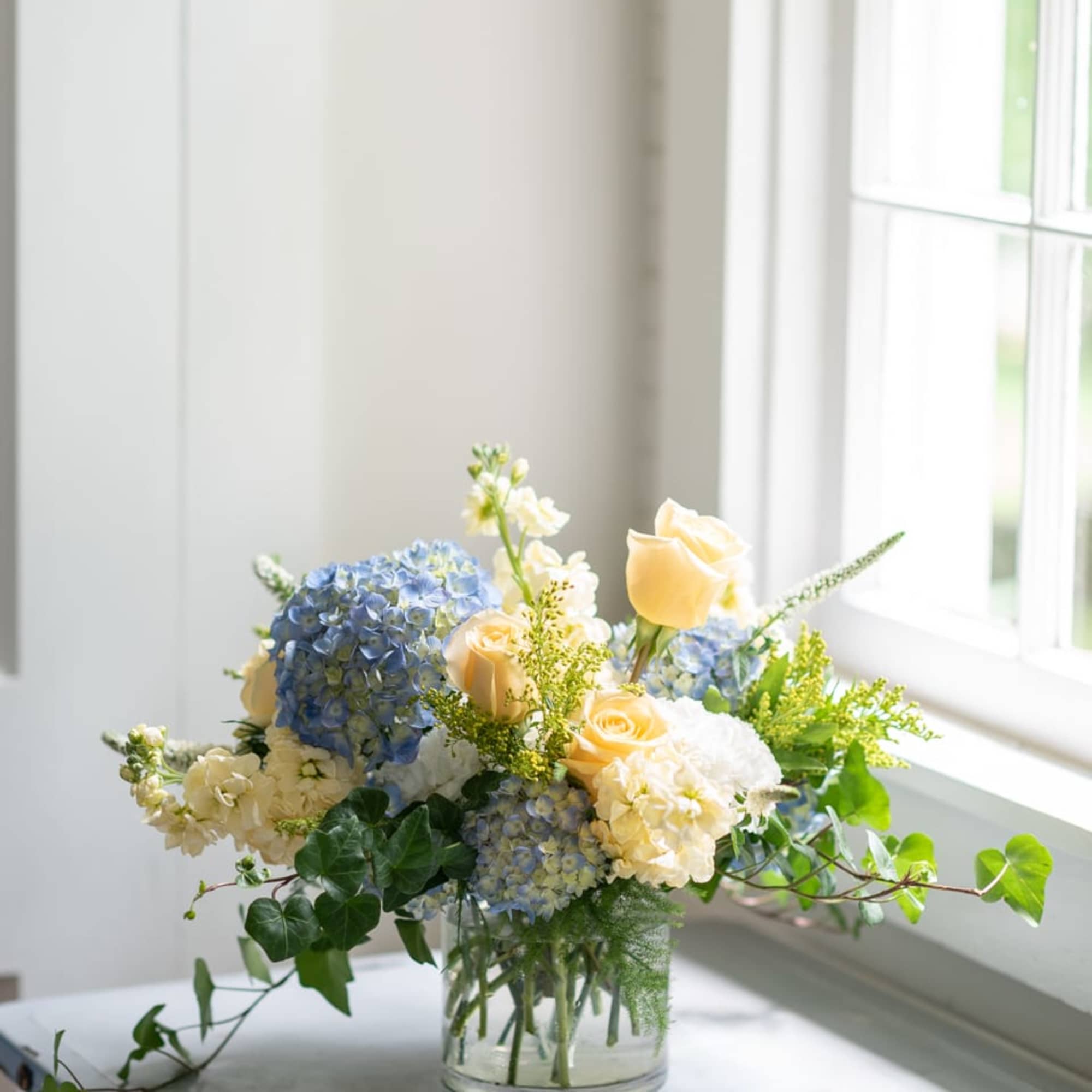 Simple reminders of summertime in the south... Lush blue hydrangeas with roses