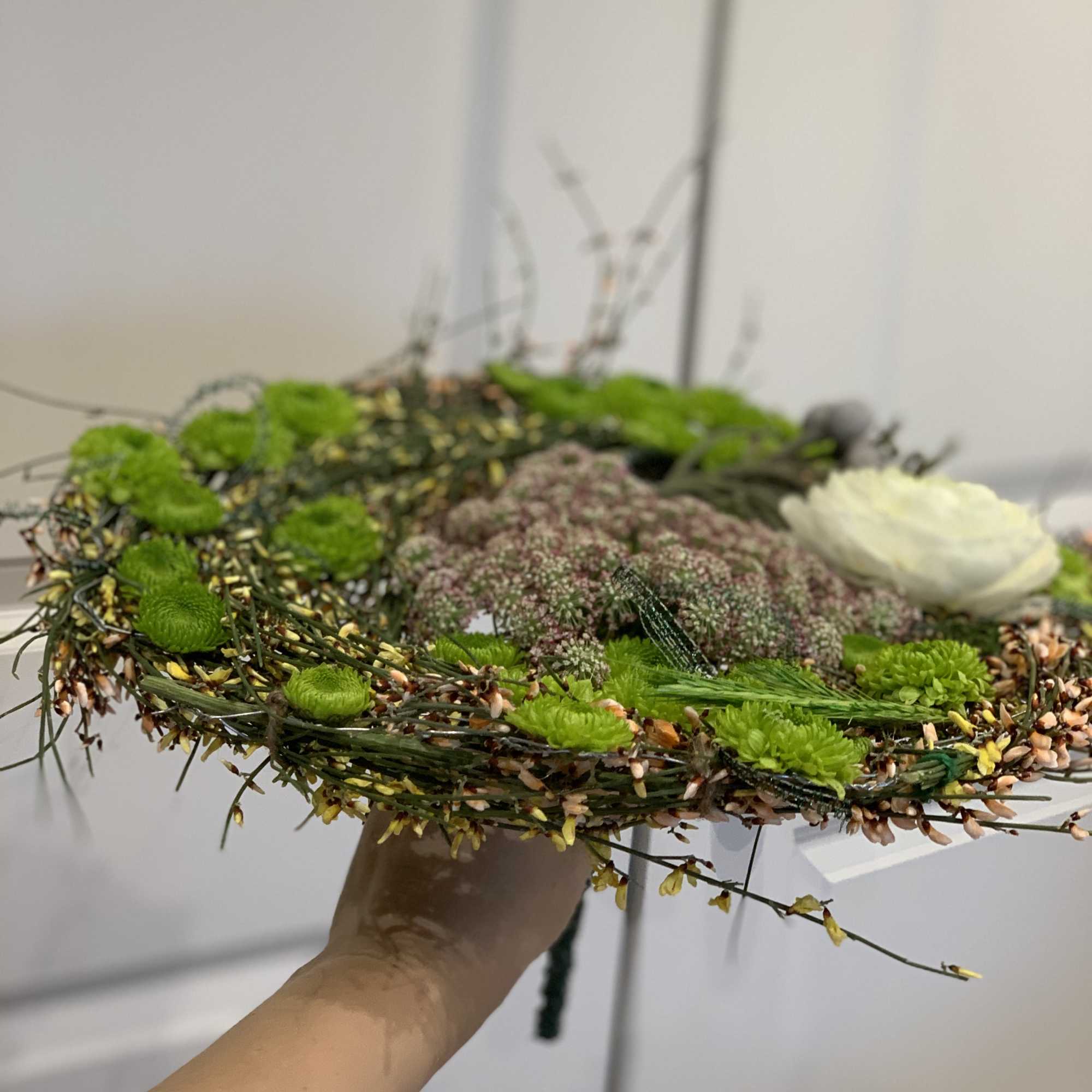 made from different grasses, ranunculus added and other seasonal flowers