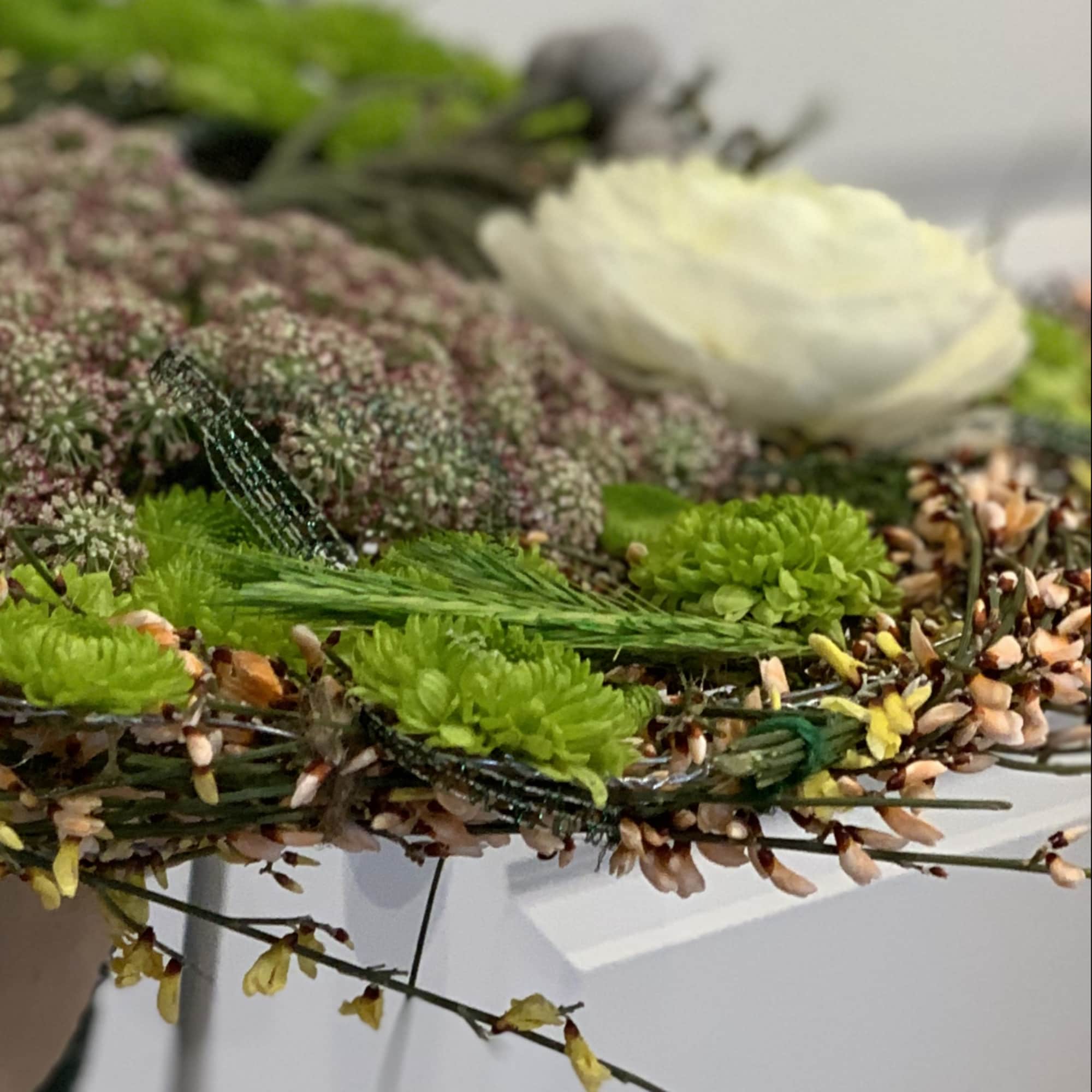 made from different grasses, ranunculus added and other seasonal flowers
