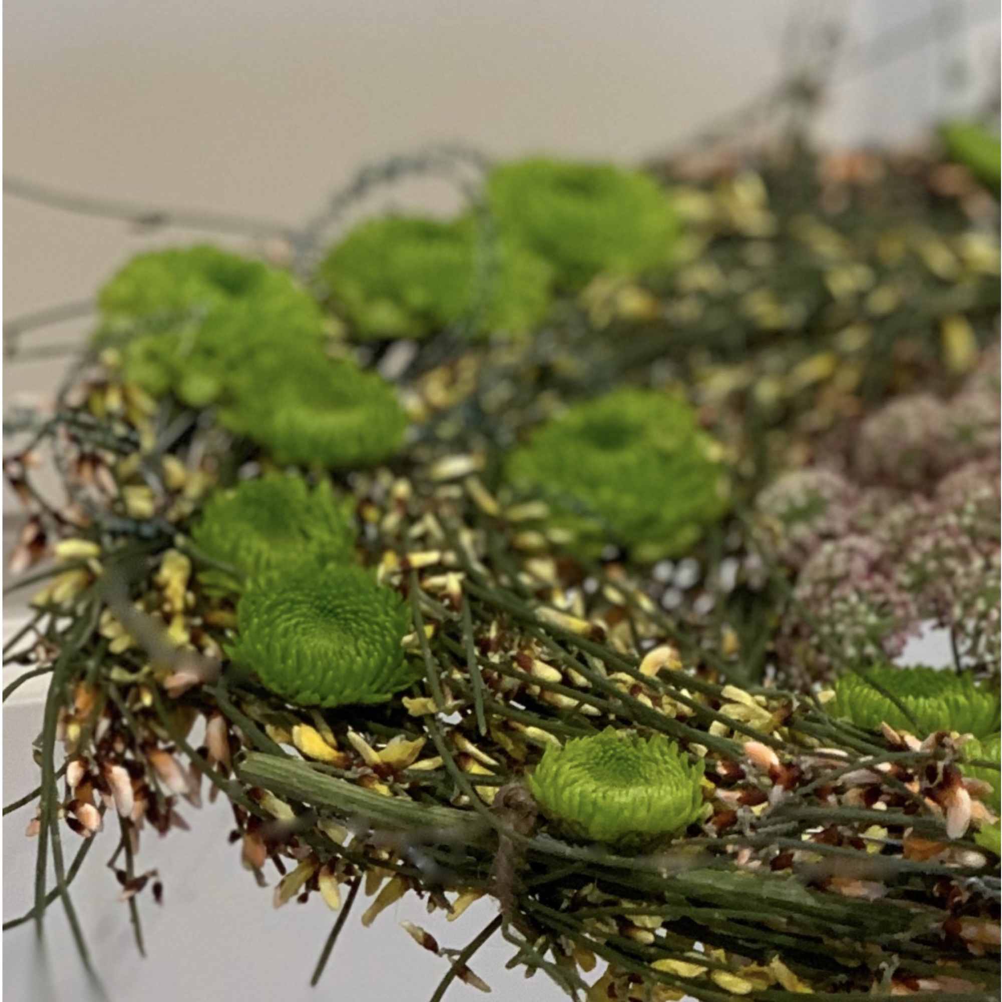 made from different grasses, ranunculus added and other seasonal flowers