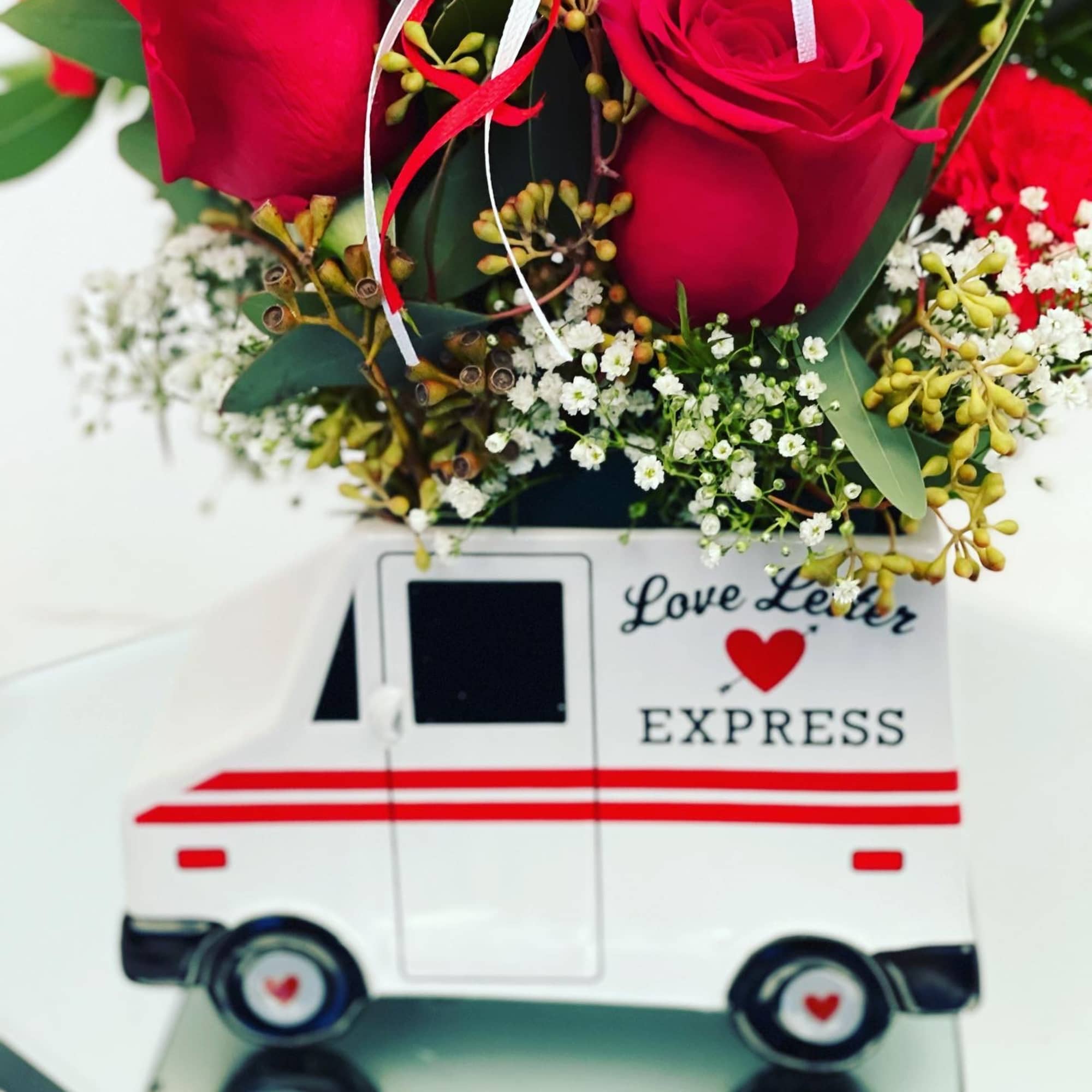In a cute mail man vase  In a cute mail man vase
