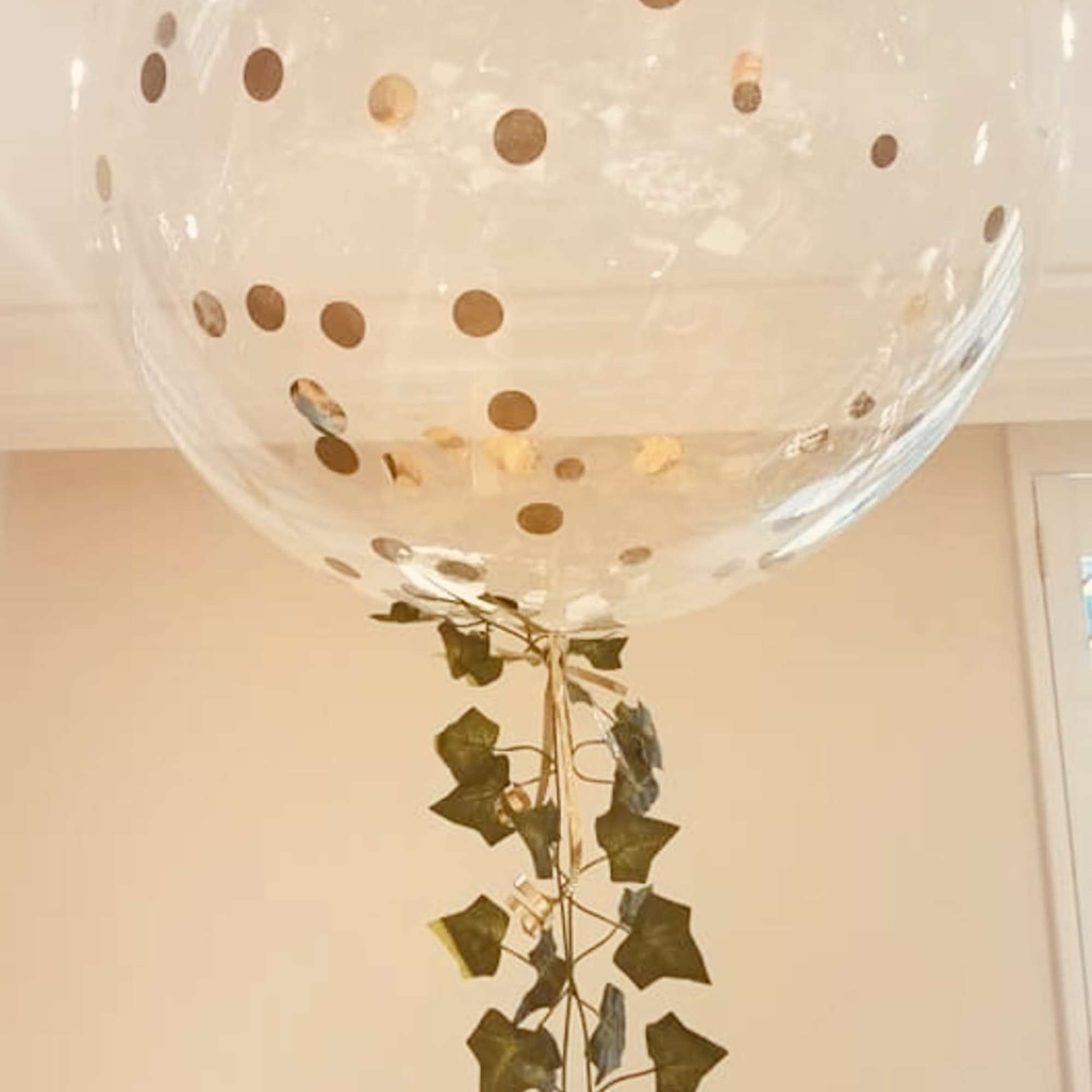 Organic bubble balloon of 18 inch inflated with helium. Gold round confetti