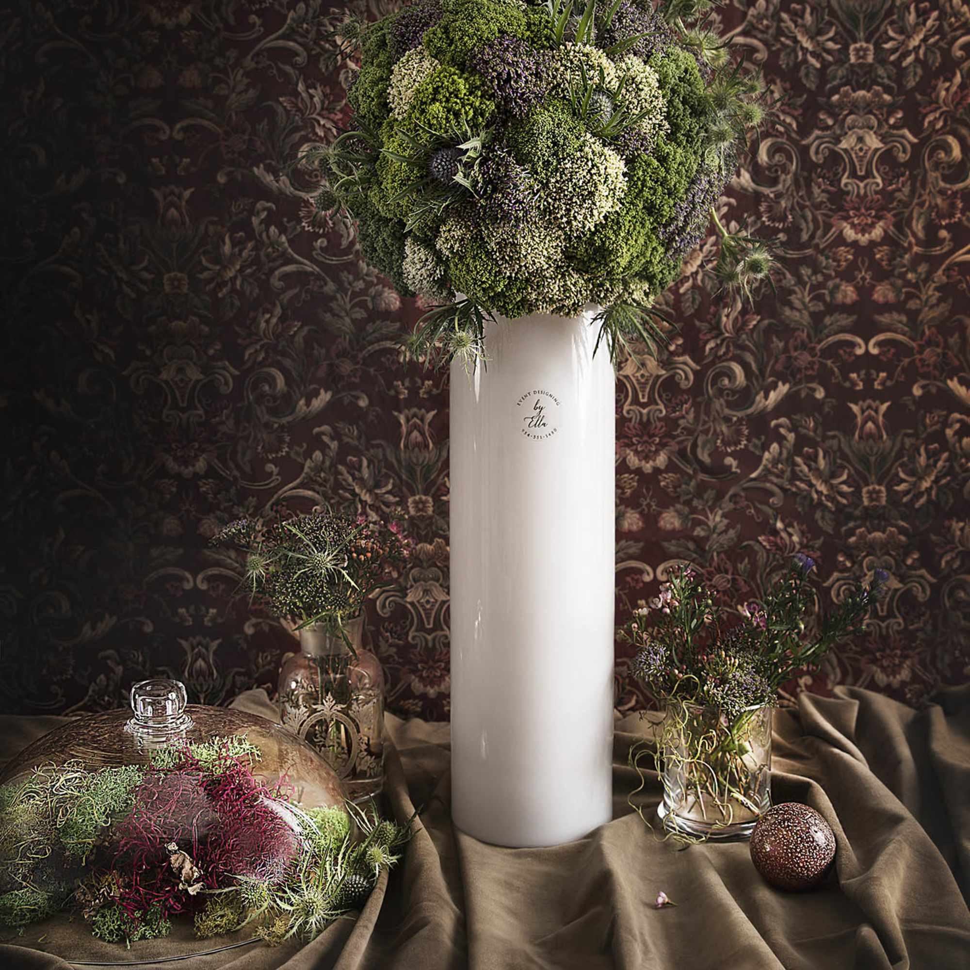 Tall arrangement in a a glass vase served for the price itself