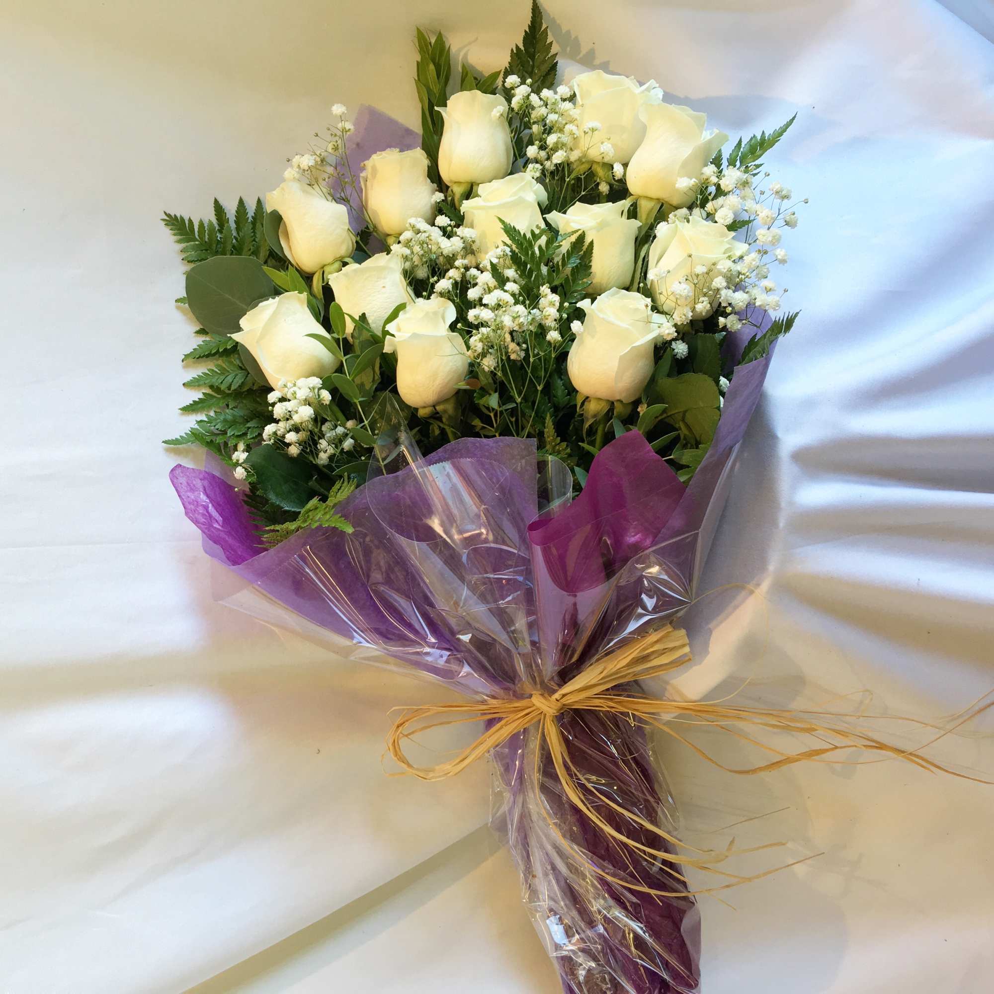 A dozen of rose wrapped nicely in paper. Color, size and design