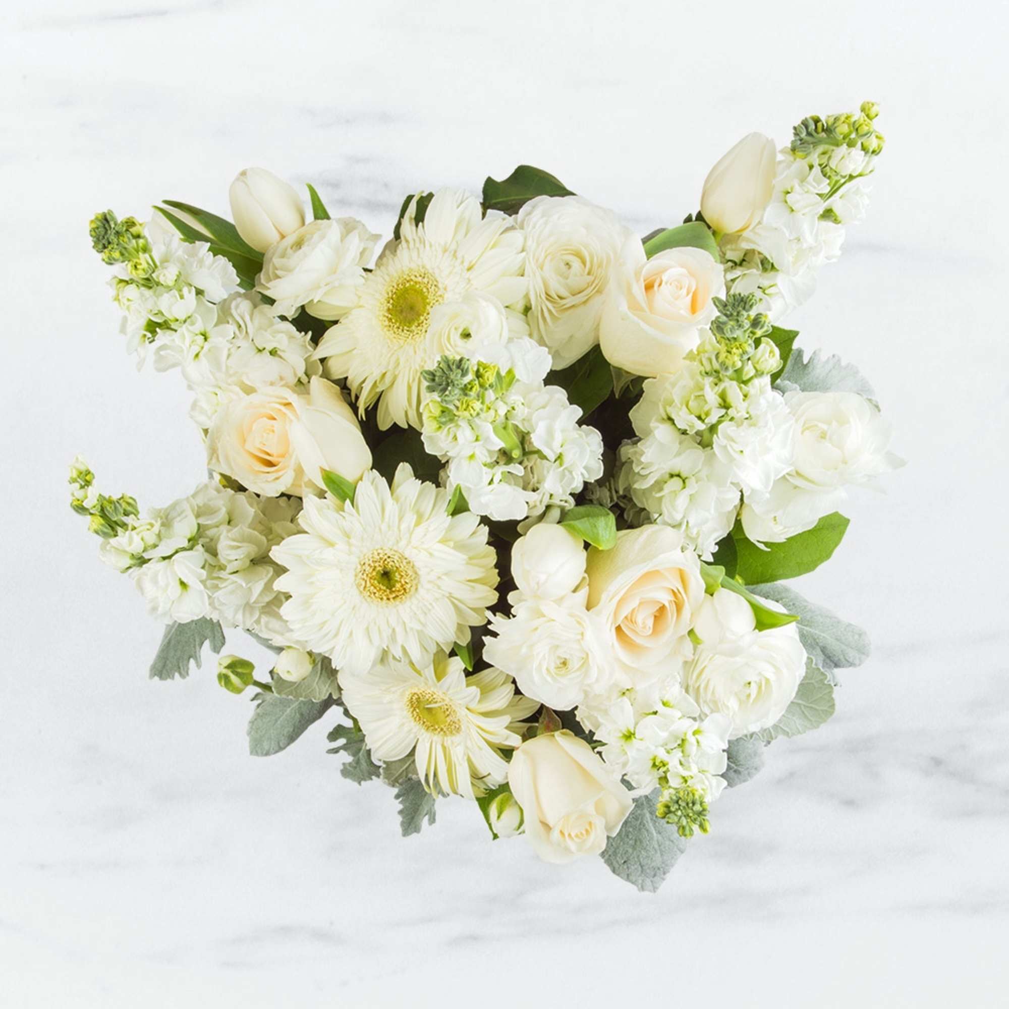 This arrangement contains a mixture of white and cream focal flowers along This arrangement contains a mixture of white and cream focal flowers along