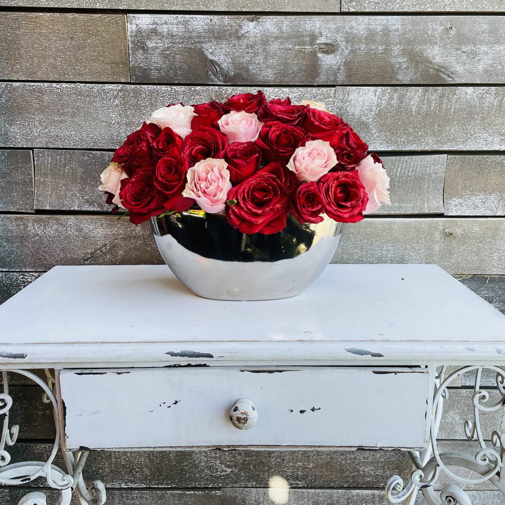 Red and pink roses in a silver container Red and pink roses in a silver container