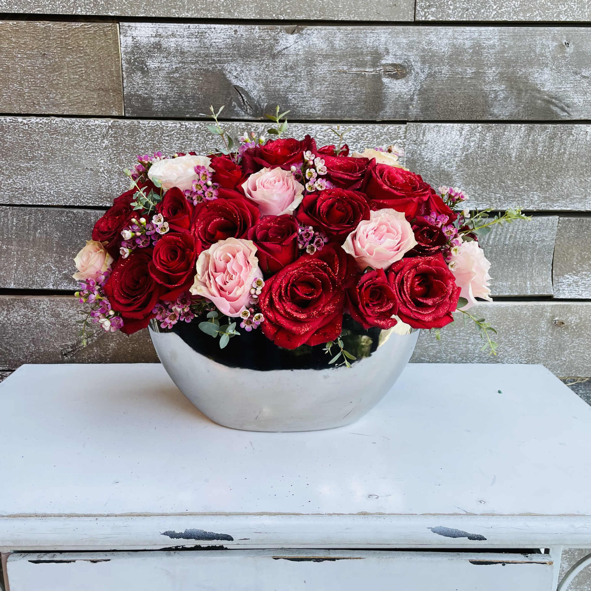 Red and pink roses with pink waxflower Red and pink roses with pink waxflower