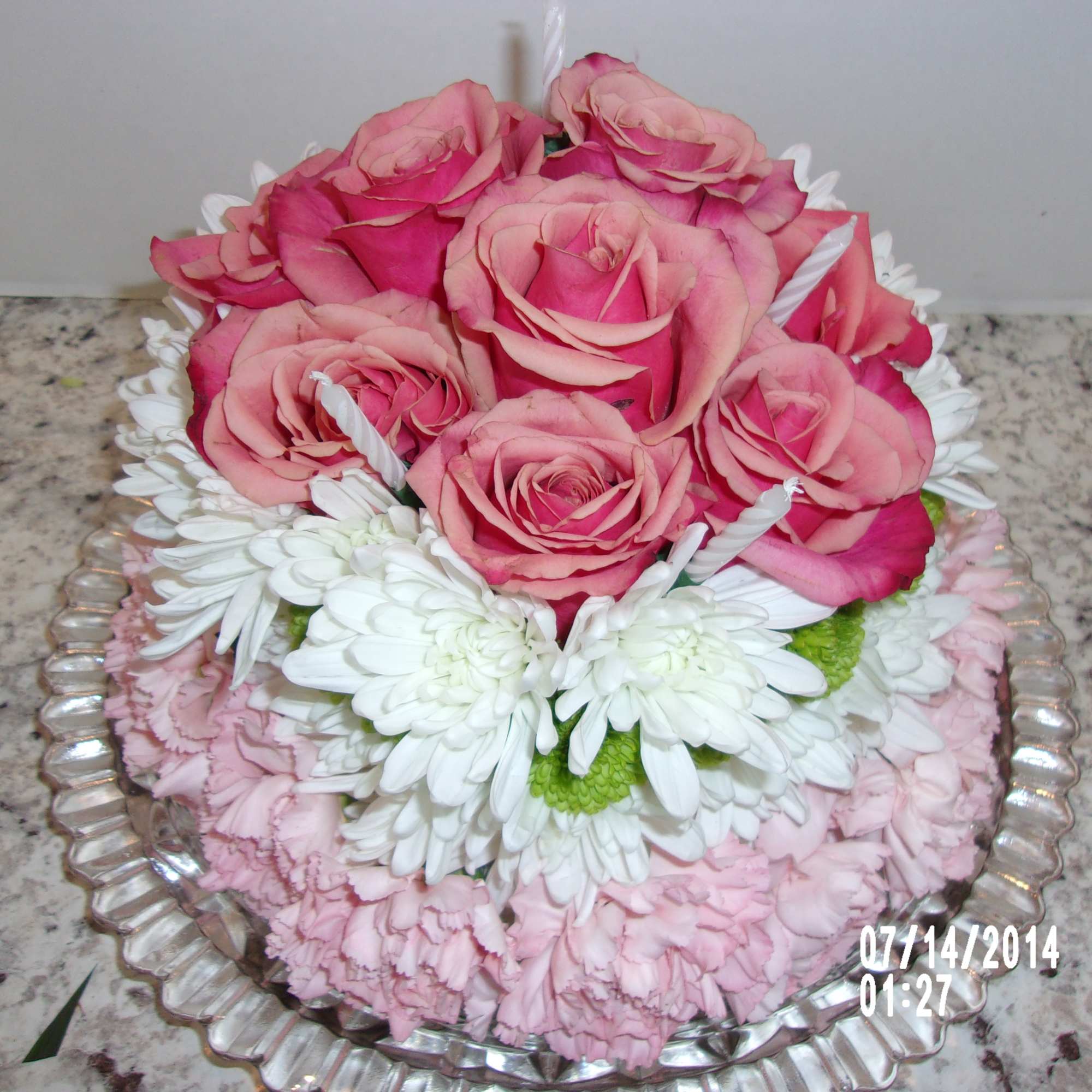 this is a cake made completely out of carnations daisies and roses.