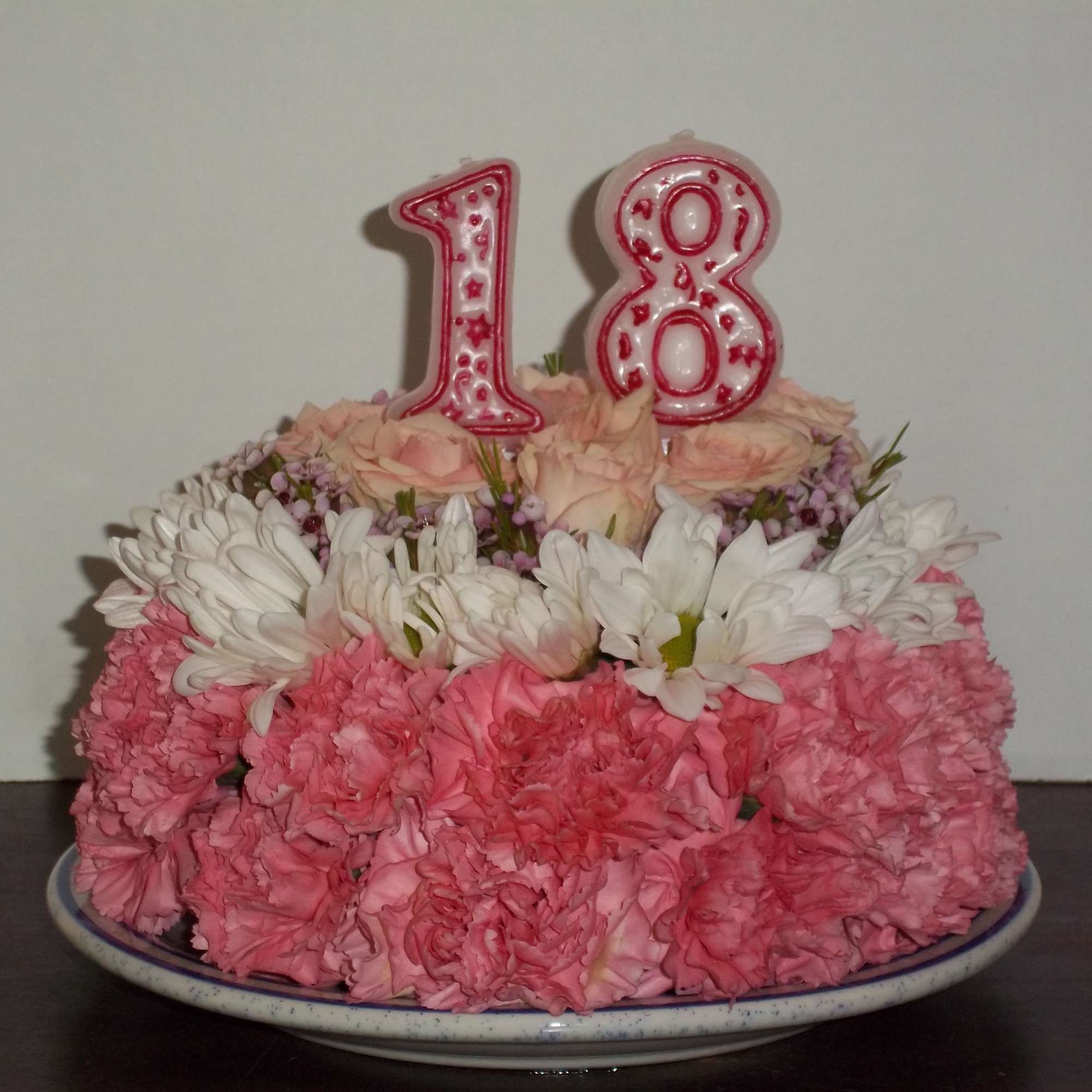 this is a cake made completely out of carnations daisies and roses.