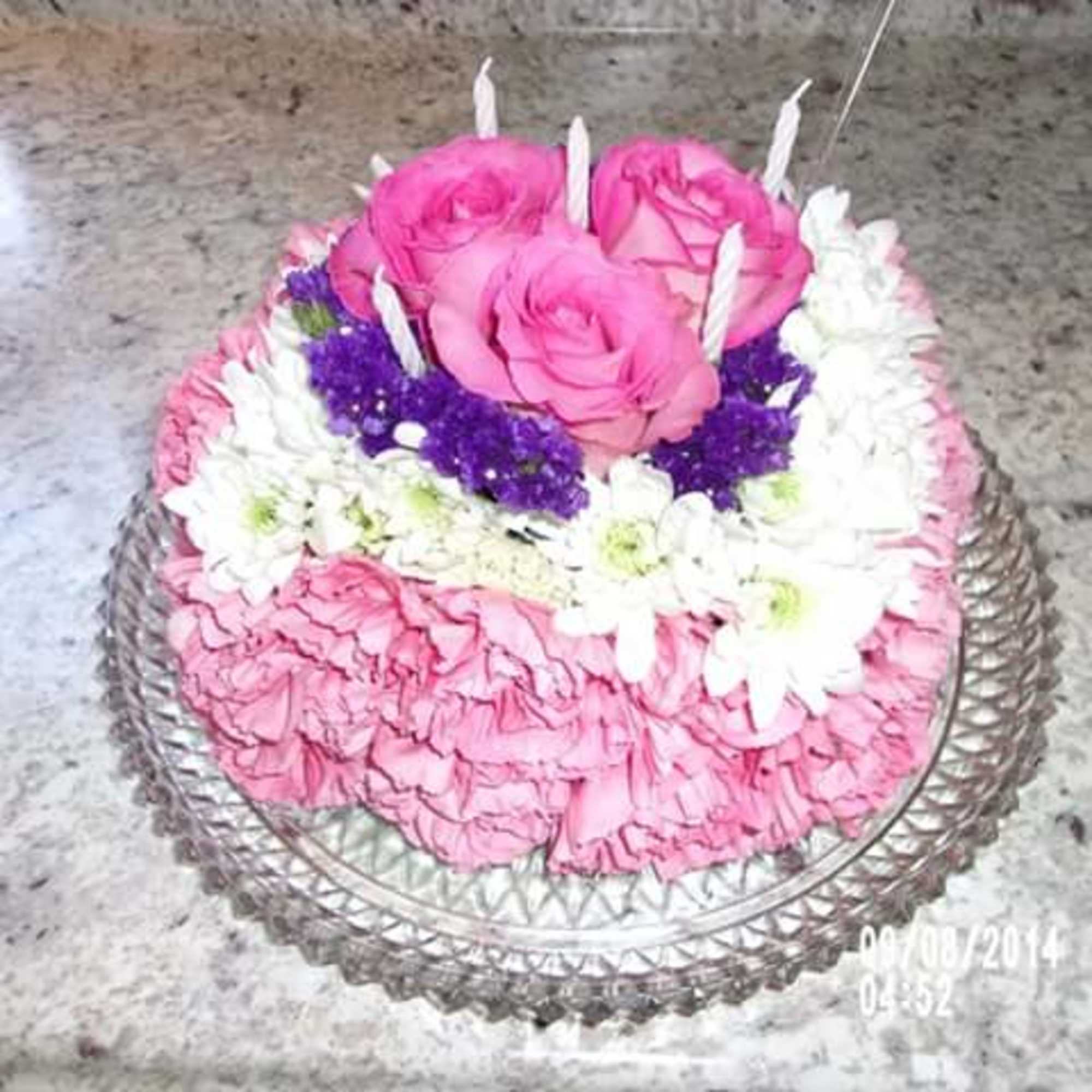 this is a cake made completely out of carnations daisies and roses.