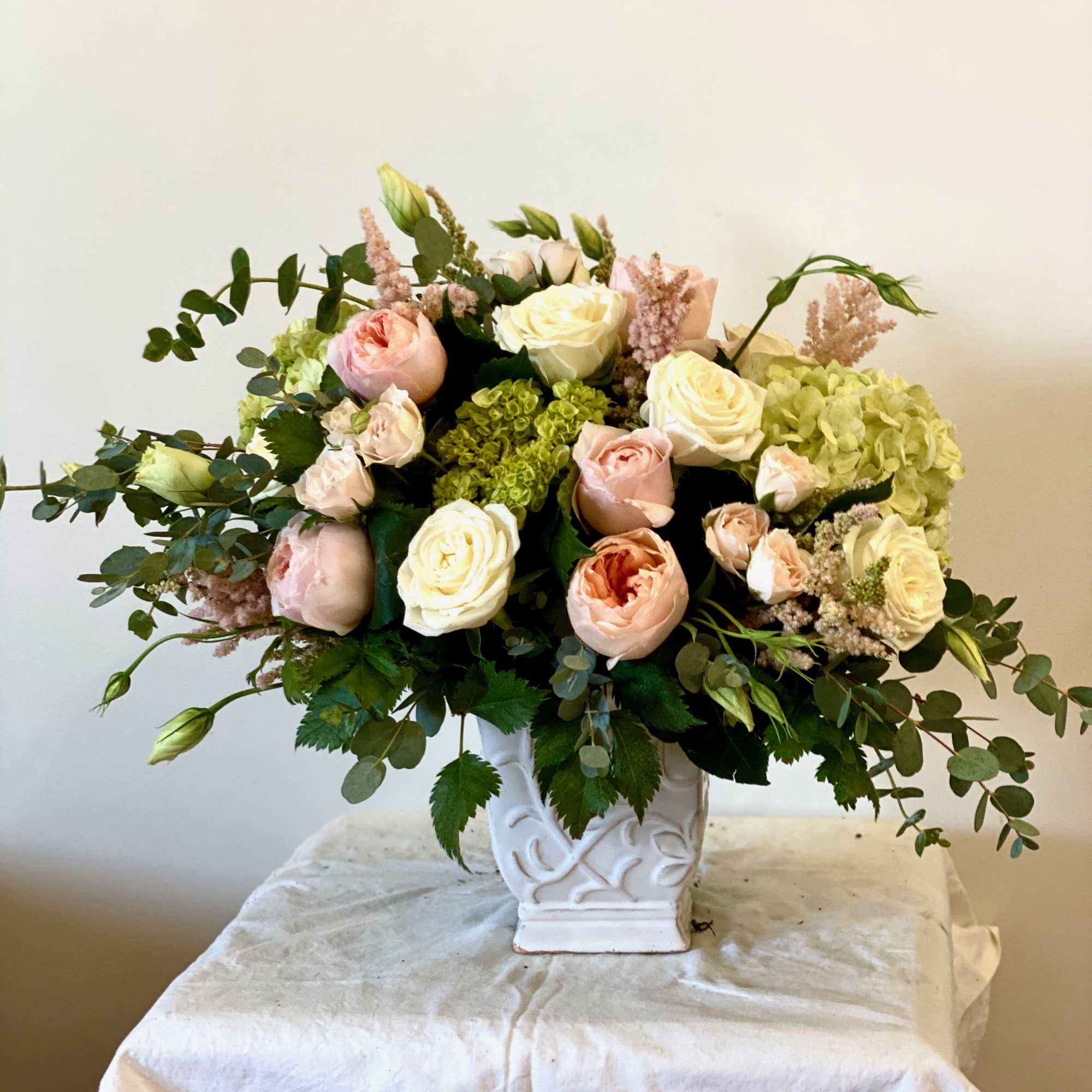 Equidorian Peach roses, ranunculus (when in season) and spray roses with hydrangea