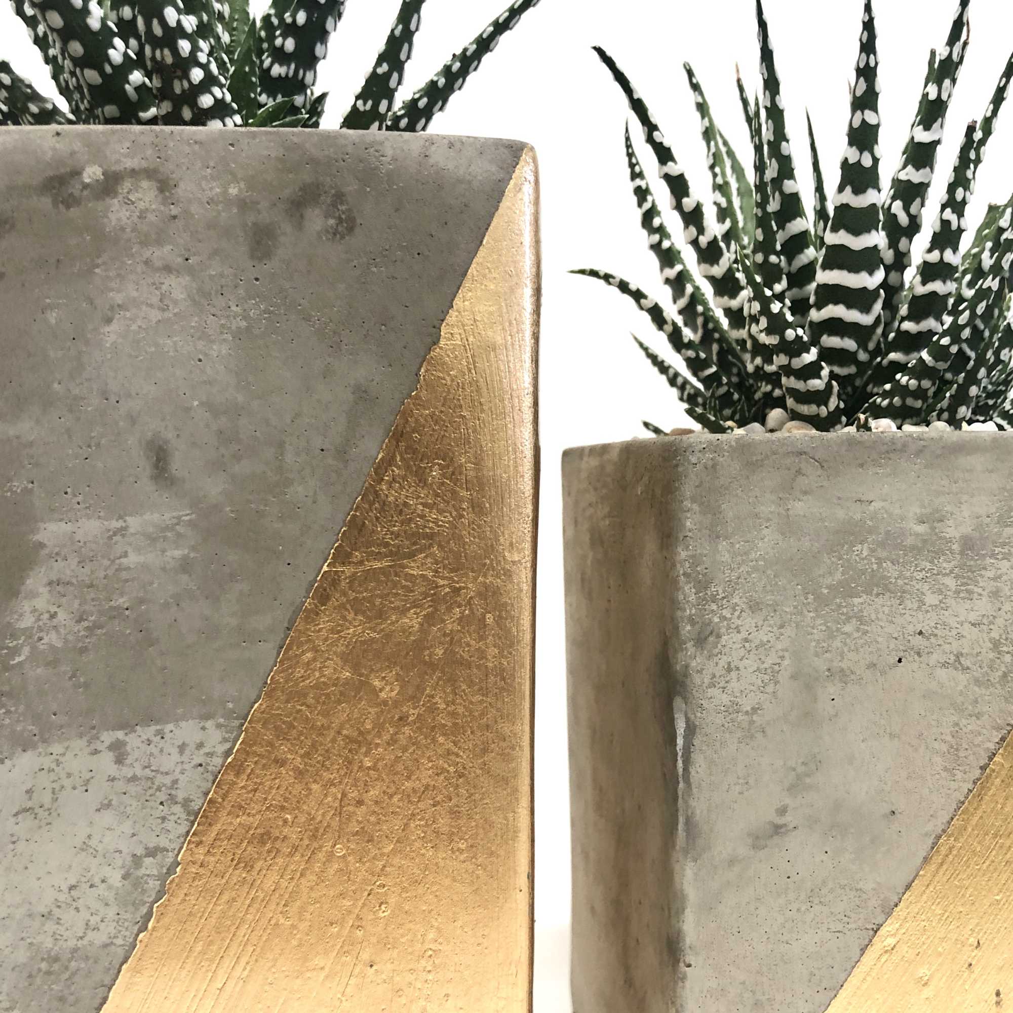 Set of 3 concrete vases with gold design. Set of 3 concrete vases with gold design.