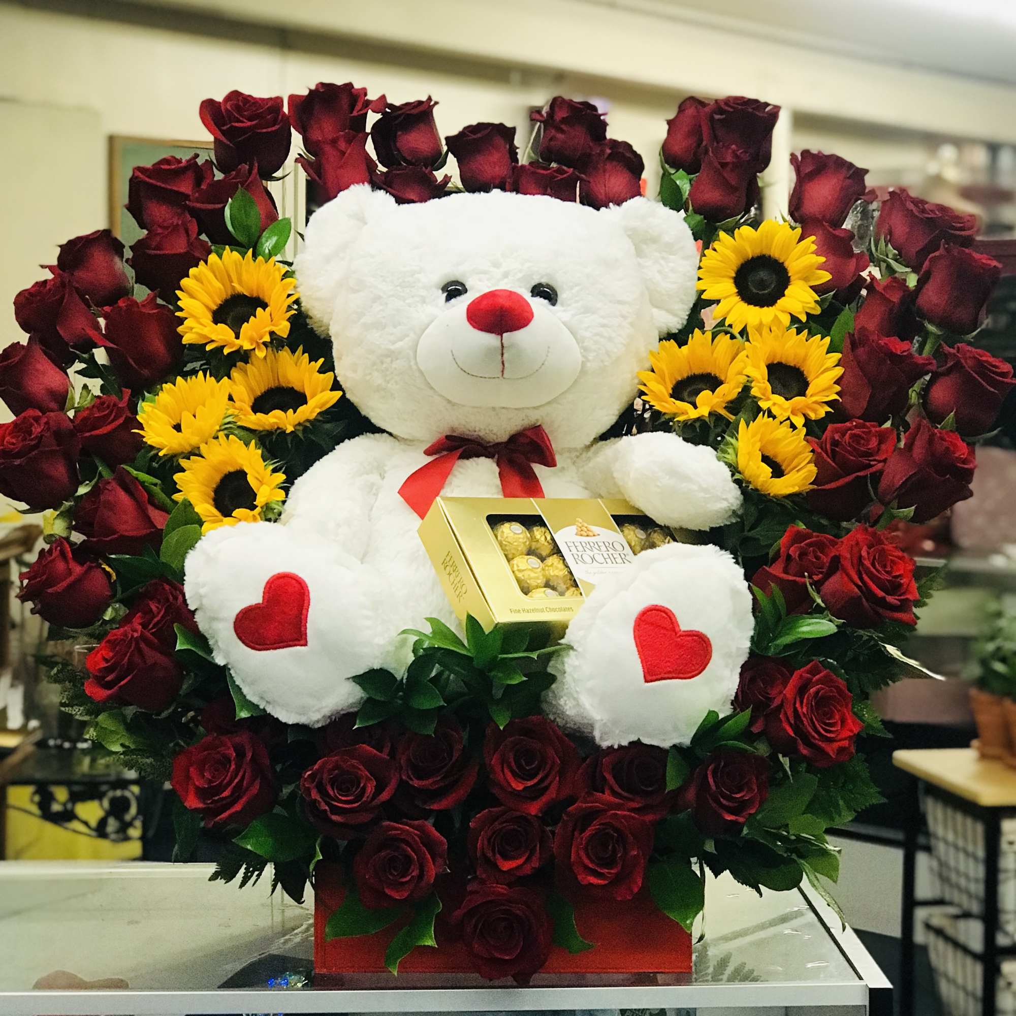 This arrangement has about 55-60 roses in a heart shape arch where