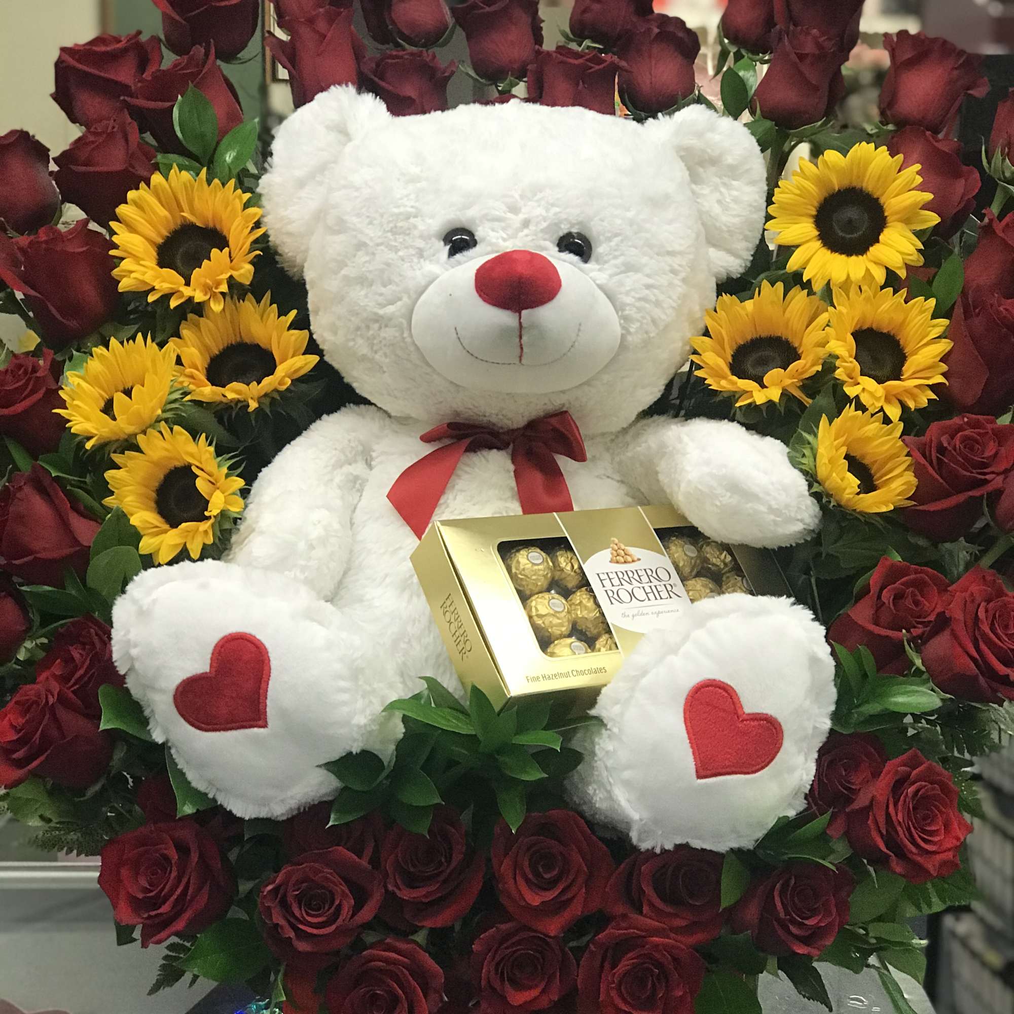 This arrangement has about 55-60 roses in a heart shape arch where