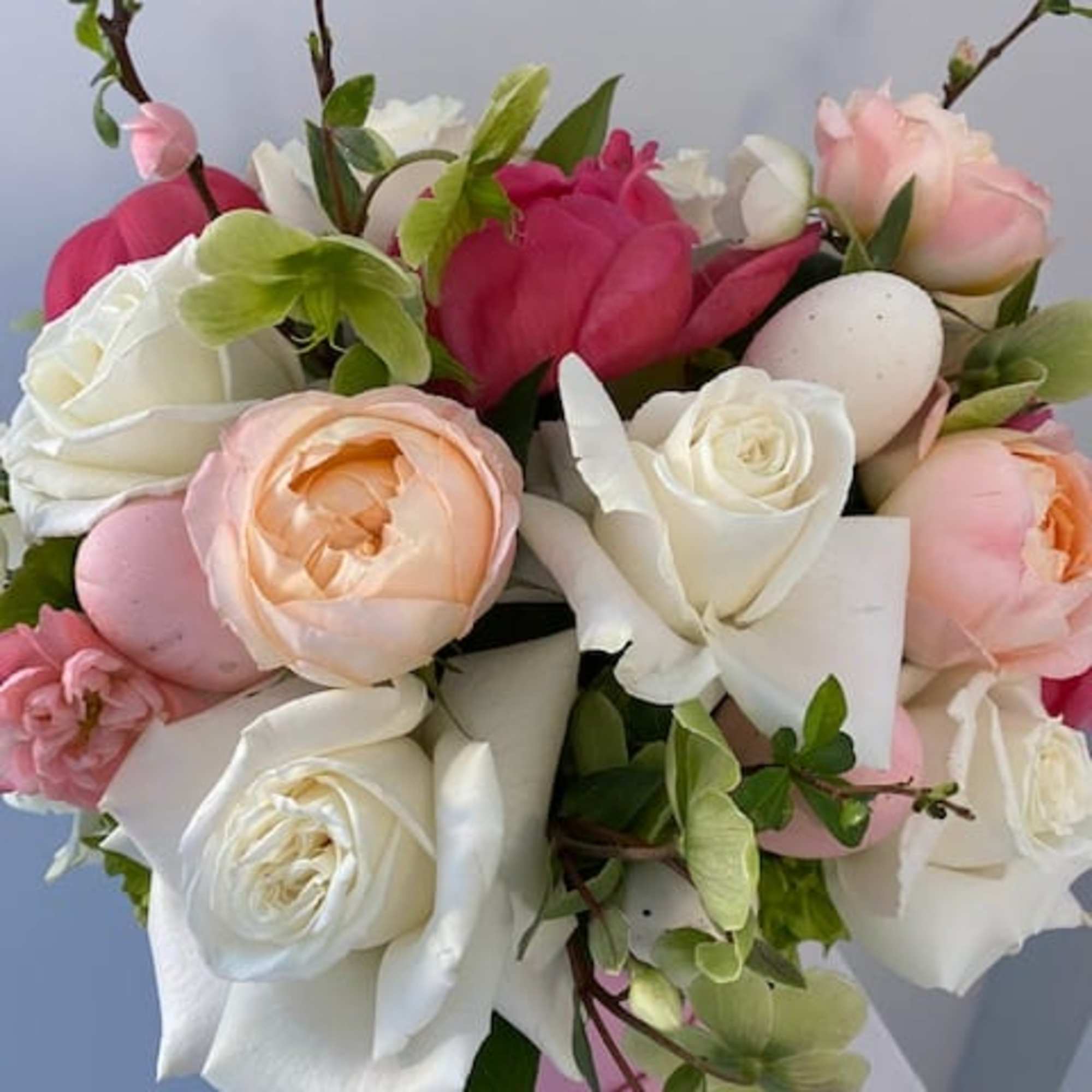 Box filled with roses, garden roses, peonies, hellebore