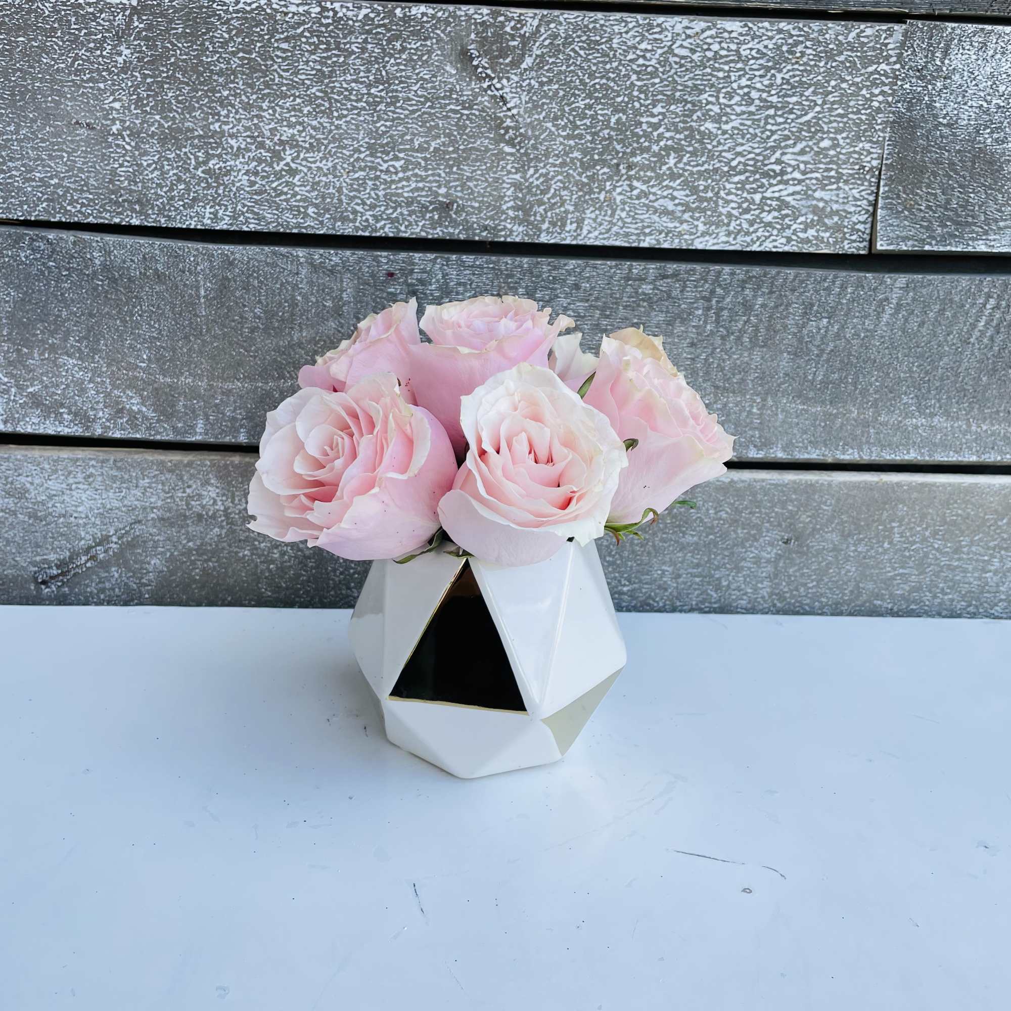 1/2 dozen pink roses in a small bud vase pave style 1/2 dozen pink roses in a small bud vase pave style